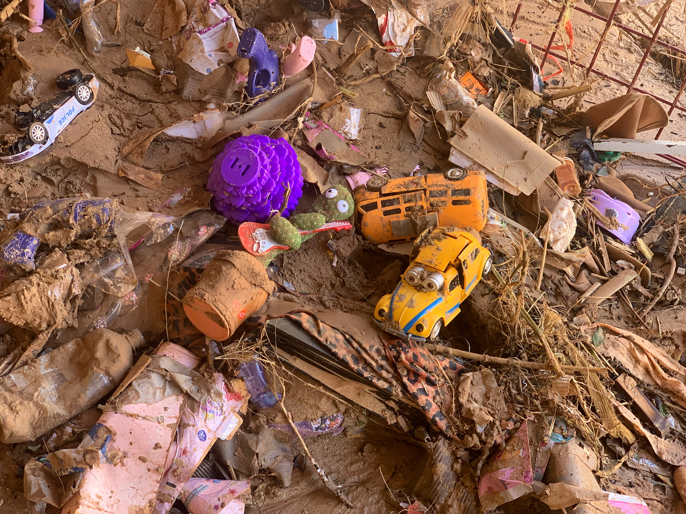 Toys are scattered outside a damaged house in Derna on Sept.14.  (Yousef Murad—AP)