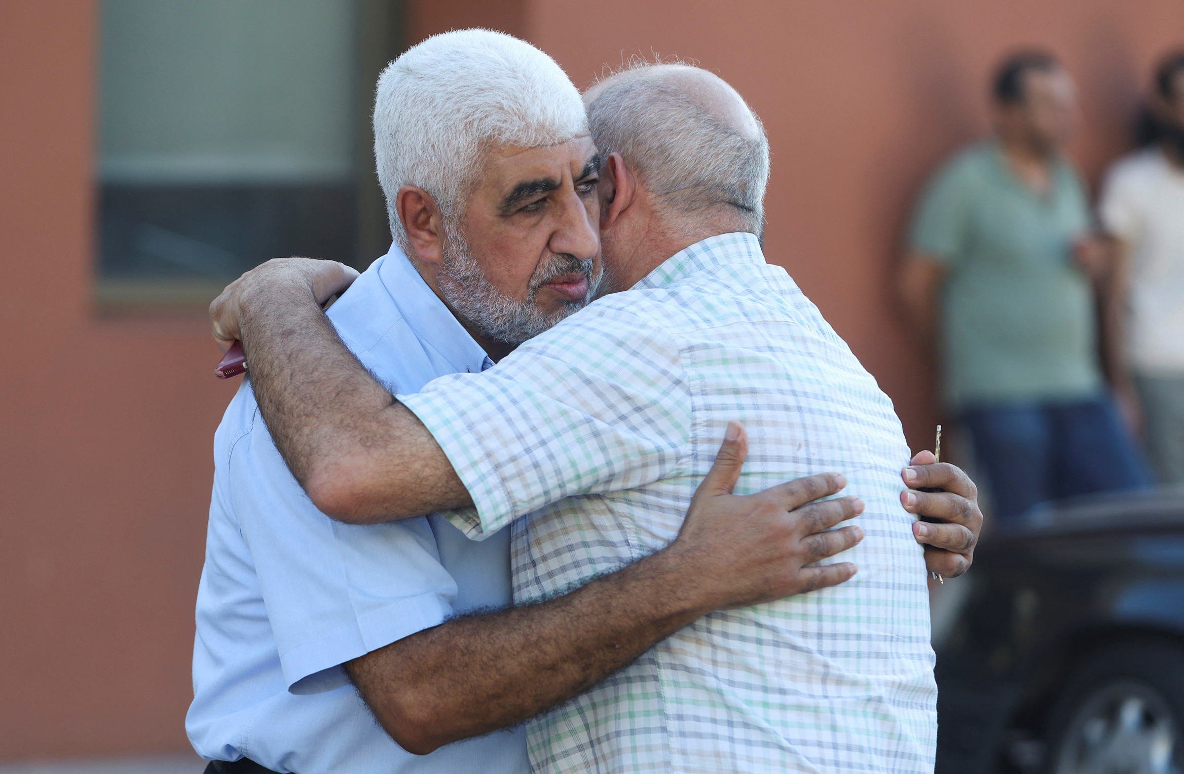 Mohammed Sariyeh hugs a man as he accepts condolences for the death of his brother Saleh, his wife, and two of his daughters who died during a powerful storm in Libya, in Sidon, on Sept. 14. (Aziz Taher—Reuters)