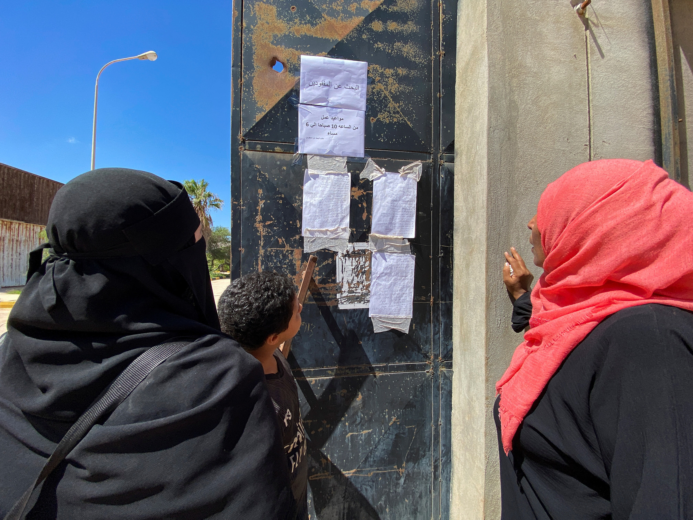 People look at the list of missing people in the aftermath of the floods in Derna on Sept. 14.