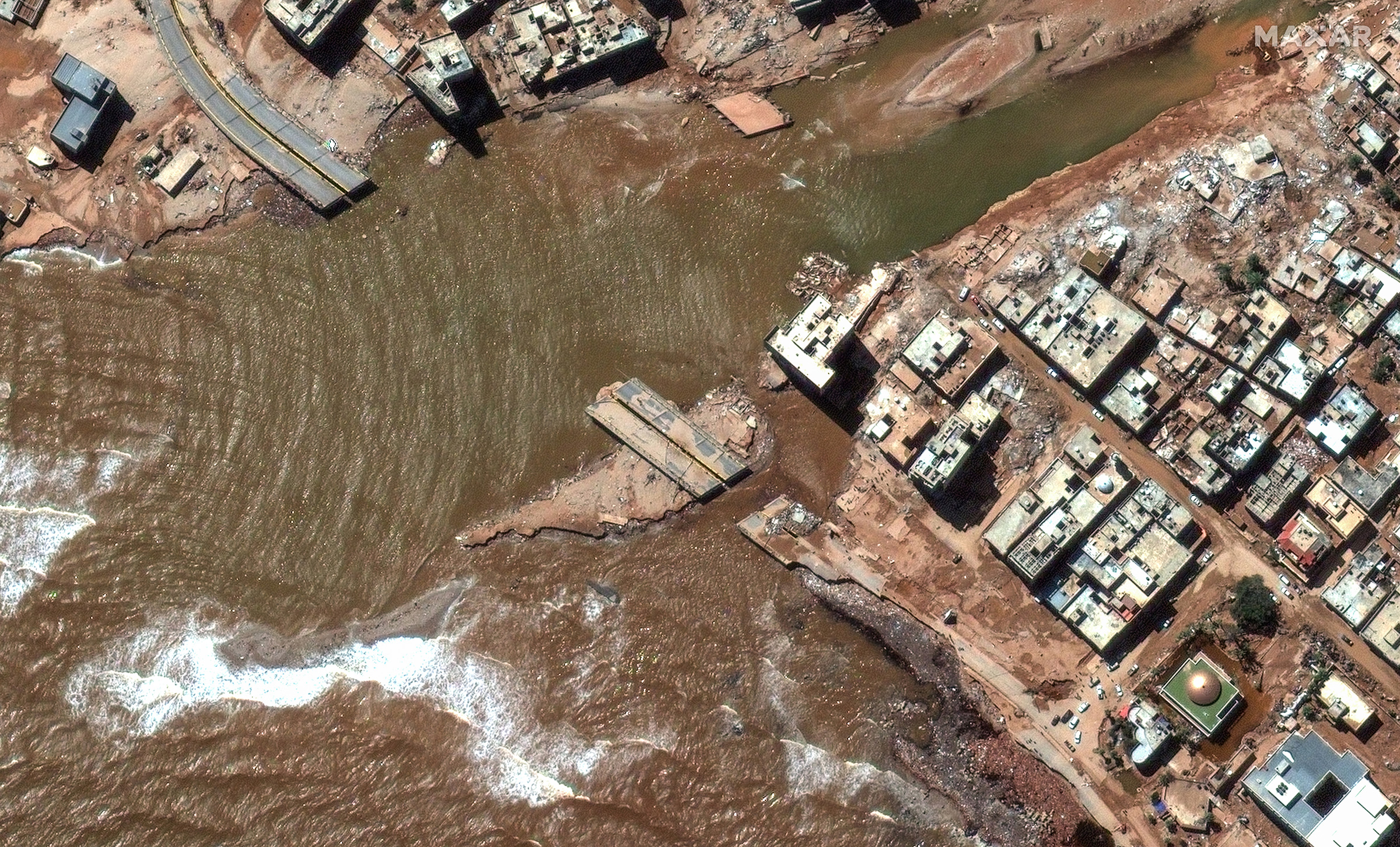 Satellite imagery of a coastal highway and buildings after the catastrophic flooding that struck the Libyan coastal city of Derna, Sept. 13.
