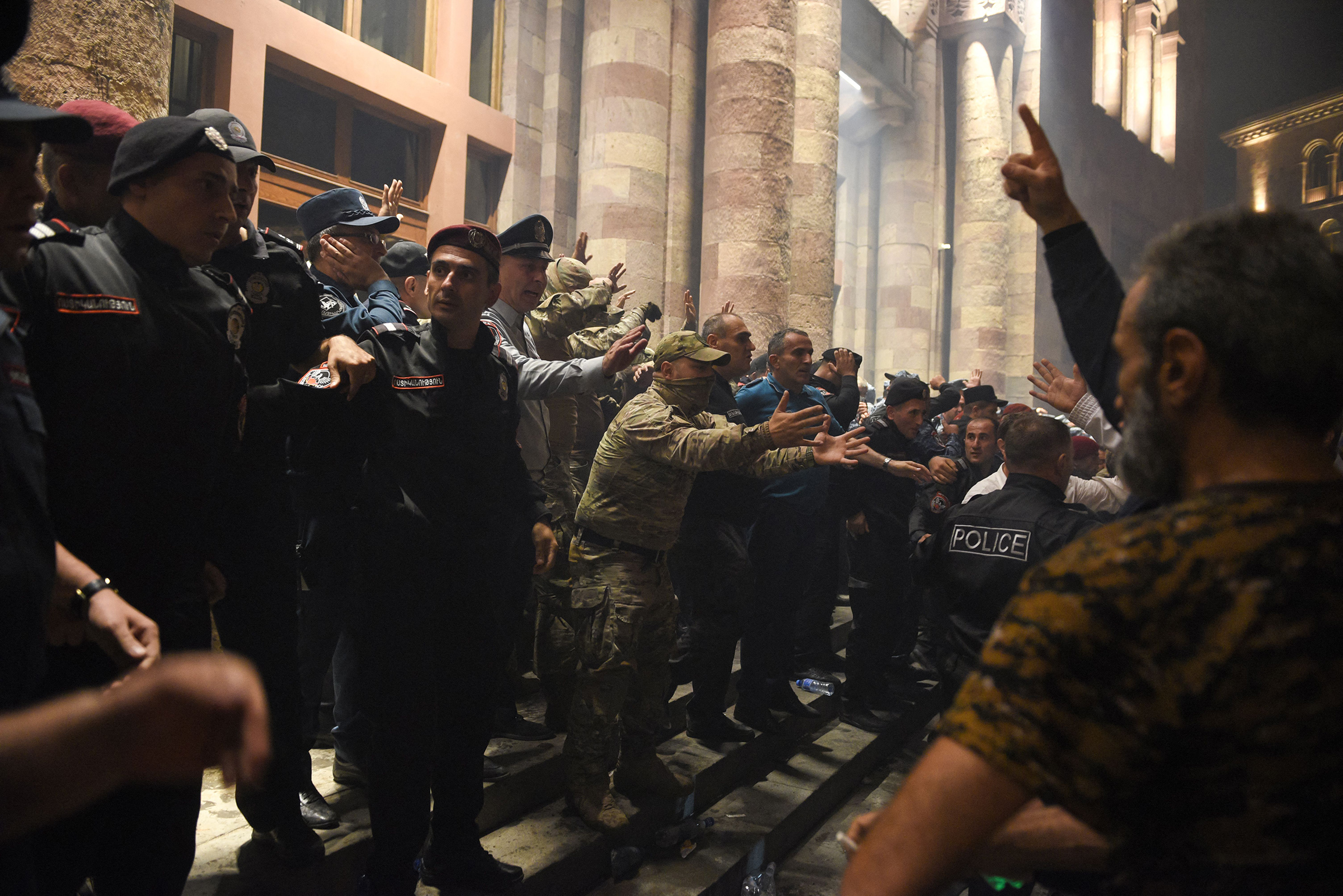 Protesters clash with police as they call on Armenian Prime Minister Nikol Pashinyan to resign in central Yerevan on Sept. 19. Azerbaijan launched a military operation against the breakaway Nagorno-Karabakh region, warning it would "continue until the end" in the territory.