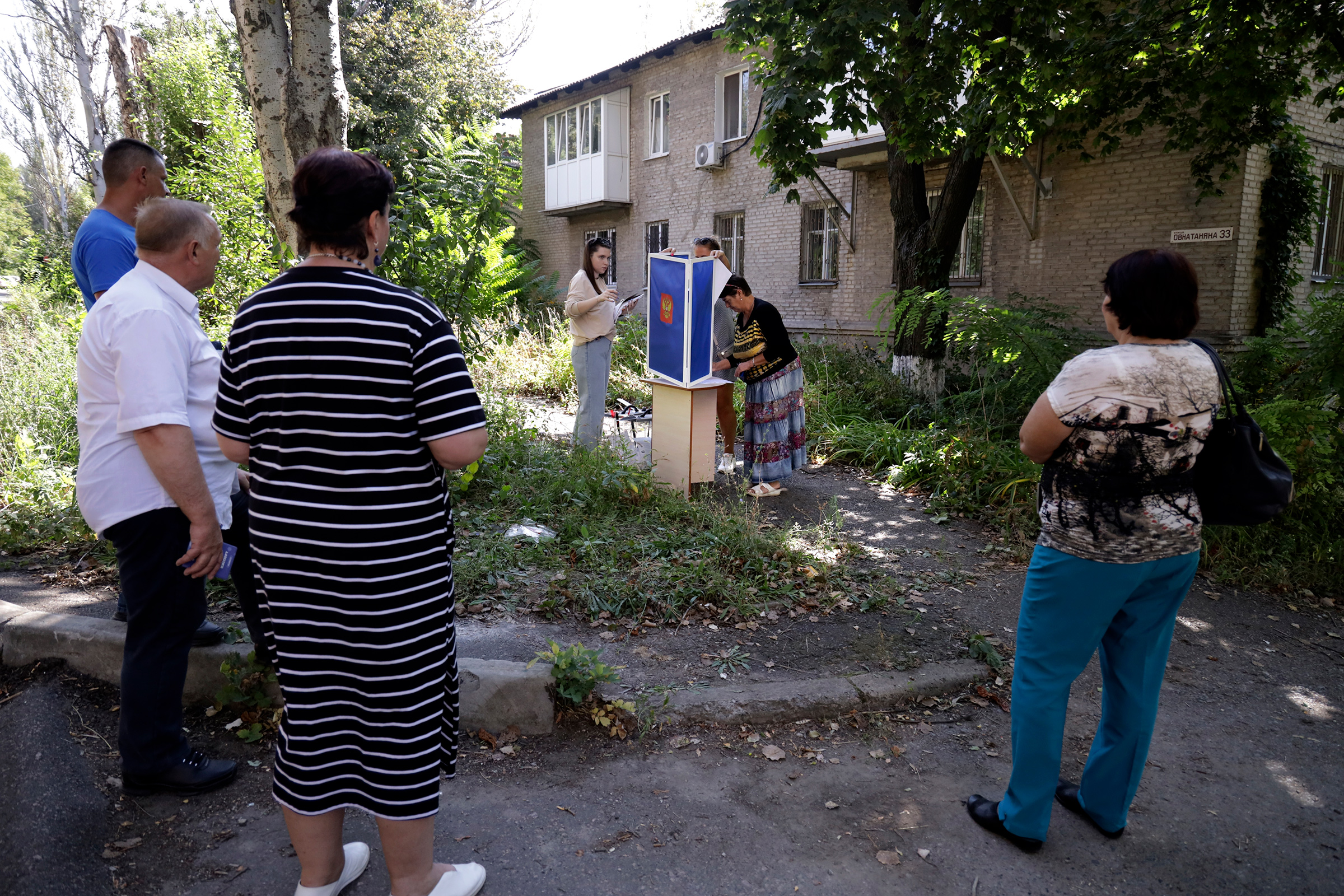 Voters gather to cast their ballots in a street near their apartment building during local elections in Donetsk, the capital of Russian-occupied Donetsk region, in eastern Ukraine, on Sept. 6. (AP)