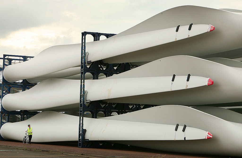 A worker passes stored wind turbine blades at the Harland &amp; Wolff shipyard on Aug. 14, 2008 in Belfast, Northern Ireland.
