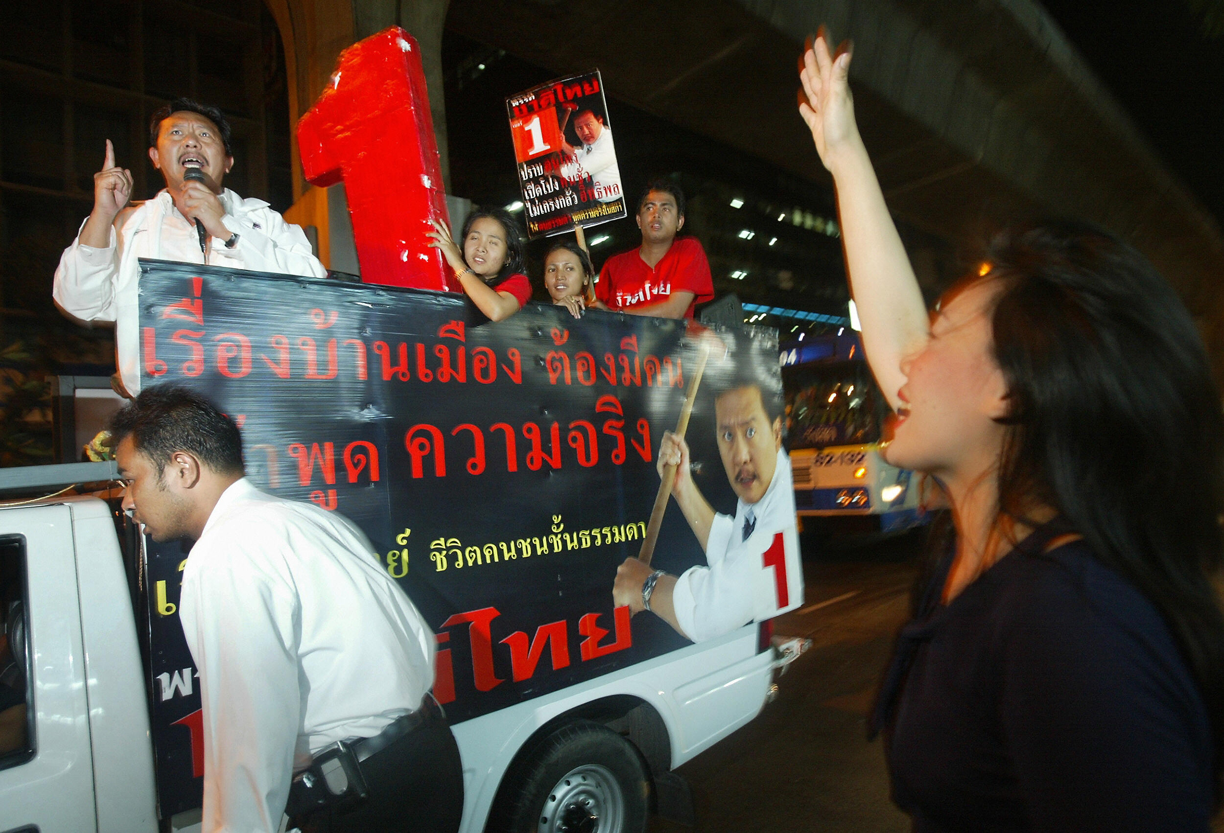 A woman shows her support for candidate Chuwit Kamolvisit as he campaigns through the city's tourist-friendly red light district of Patpong, on Feb. 4, 2005 in Bangkok.