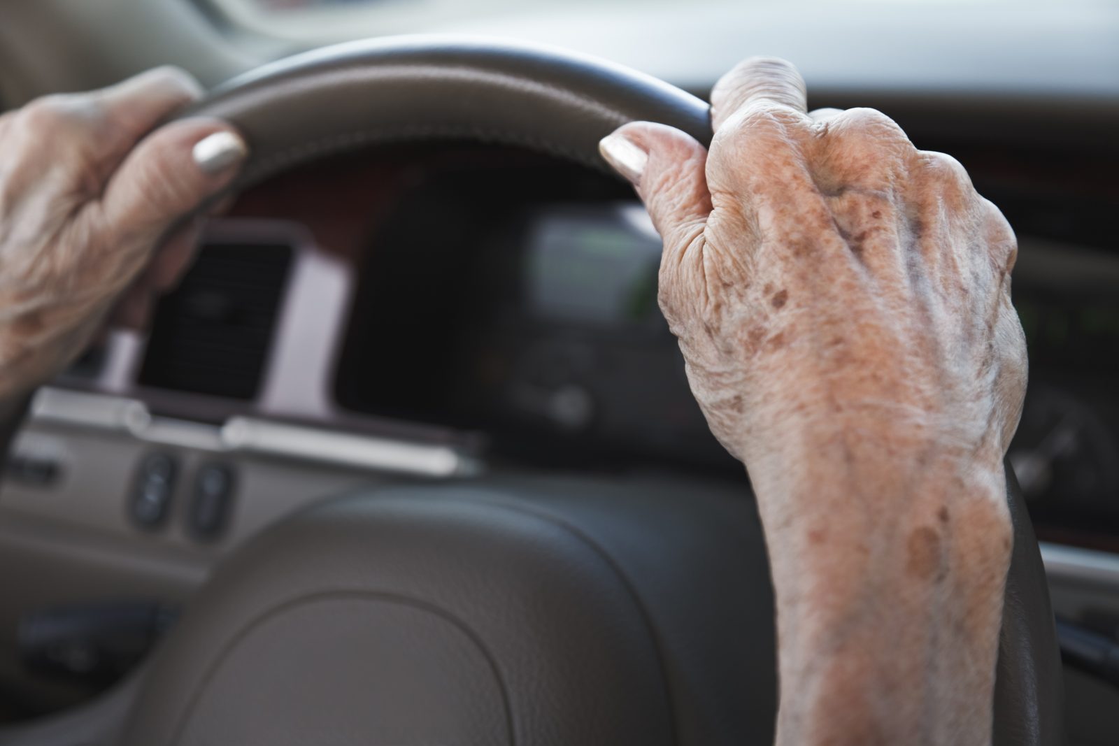 senior woman hands on steering wheel