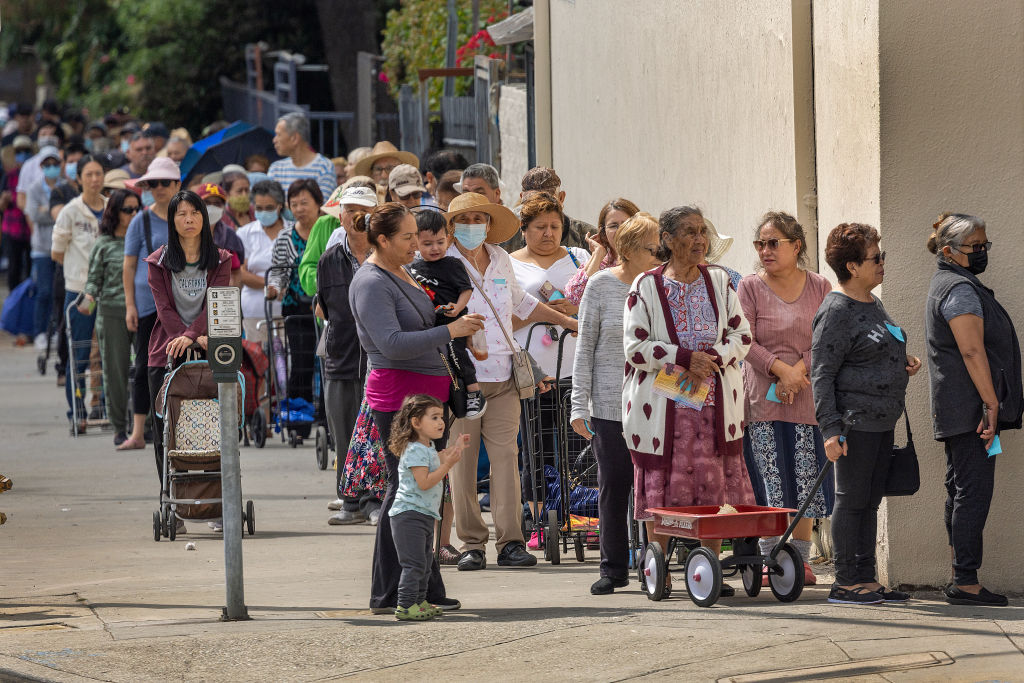 People attend a food distribution organized by embattled Los Angeles City Council member Kevin de León, who was recorded making racist remarks last fall, in Los Angeles