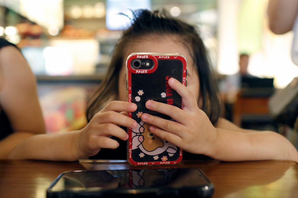 A girl uses a smartphone in Vietnam in June 2022.