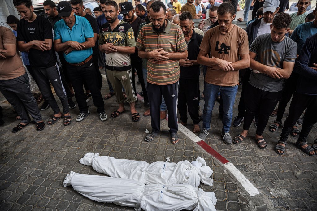Relatives of two girls who were killed by Israeli missiles during funeral prayers in Gaza City, Oct. 9.