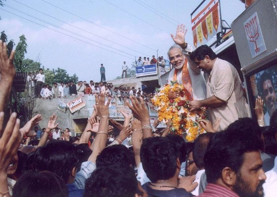 Gujarat Chief Minister Narendra Modi waves to supporters in Kadi in 2002