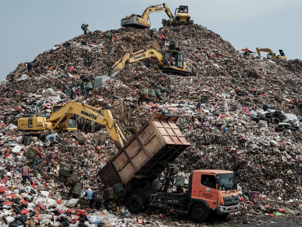 A truck unloading waste as cranes move waste up to a higher level at the Bantar Gebang landfill, which is the size of 200 football pitches and receives 7,500 tonnes of waste from Jakarta every day, in Bekasi, on the outskirts of Jakarta. Sept. 14.