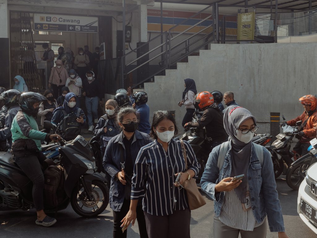 Morning commuters exit a train station in Jakarta on Aug. 22. Jakarta, the city that's home to more than 10 million people, has suffered air pollution at unhealthy levels in the past few weeks, with IQAir recently ranking it as the worlds most polluted city.