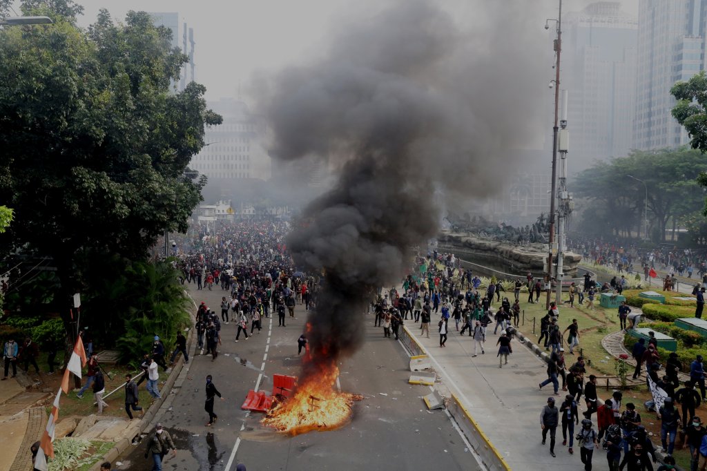 Protesters and police clash during a demonstration against the Omnibus Law on Job Creation in Jakarta on Oct. 8, 2020.