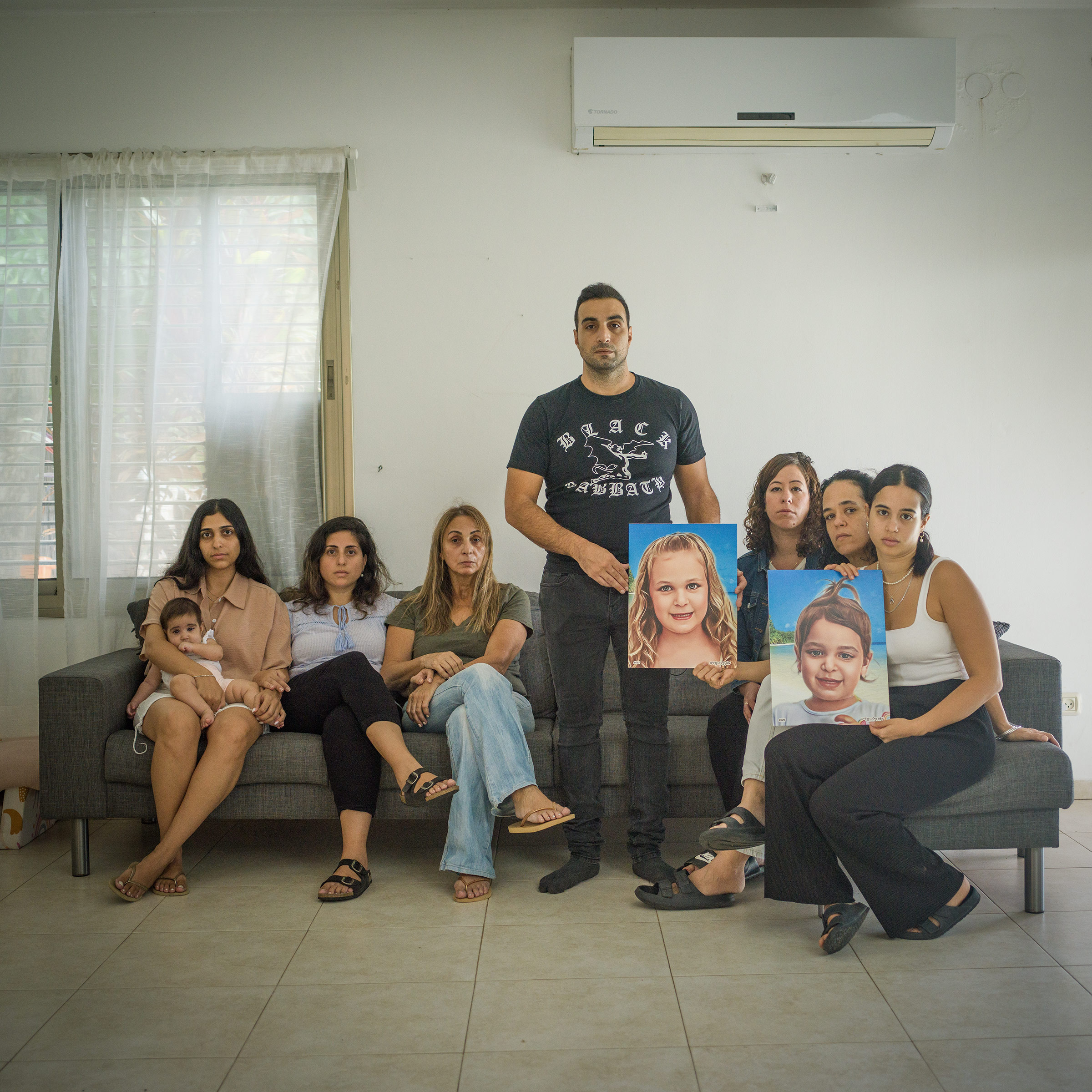 From left: Yuval Cohen holding Zohar Cohen, Yarden Greenfeld, Orna Ben Yaakov, Yoni Asher, Leeor Katz Natanzon, Michal Asraf, May Asraf in Ganot Hadar, Israel on Oct. 15.