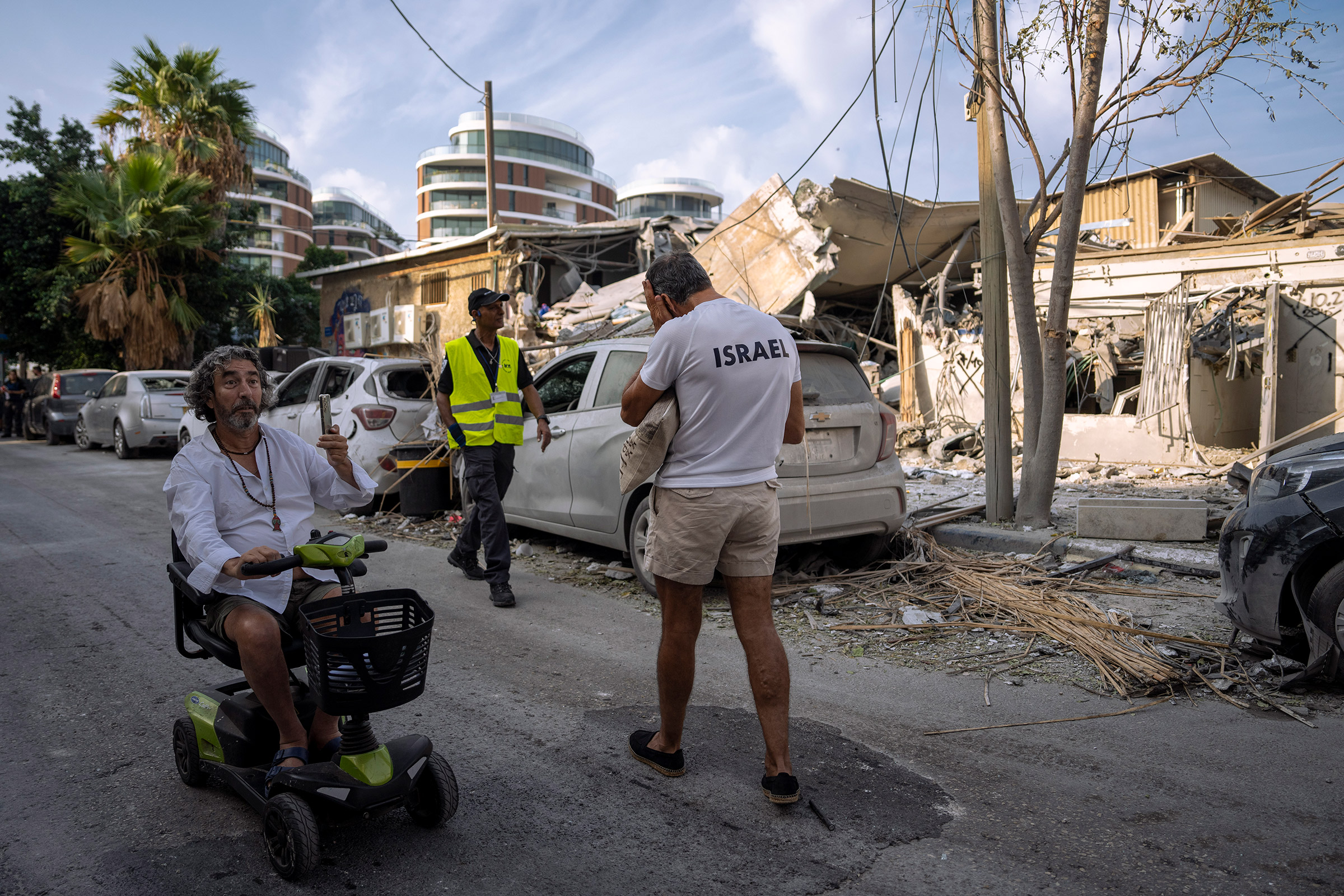 Israelis inspect the rubble of a building a day after it was hit by a rocket fired from the Gaza Strip, in Tel Aviv, Israel, on Oct. 8.