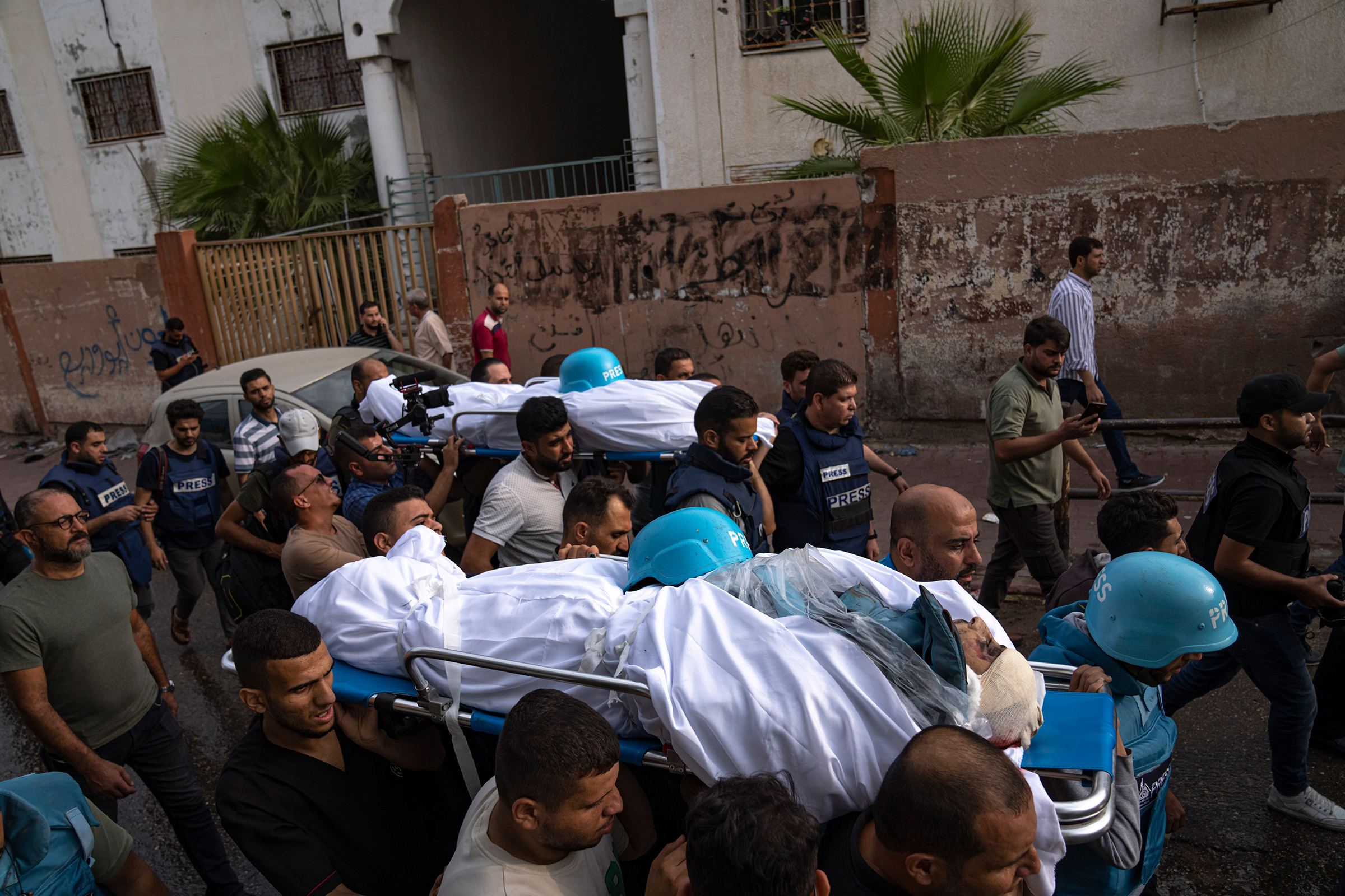 Palestinians carry the bodies of two Palestinian reporters, Mohammed Soboh and Said al-Tawil, who were killed by an Israeli airstrike in Gaza City, Oct. 10.