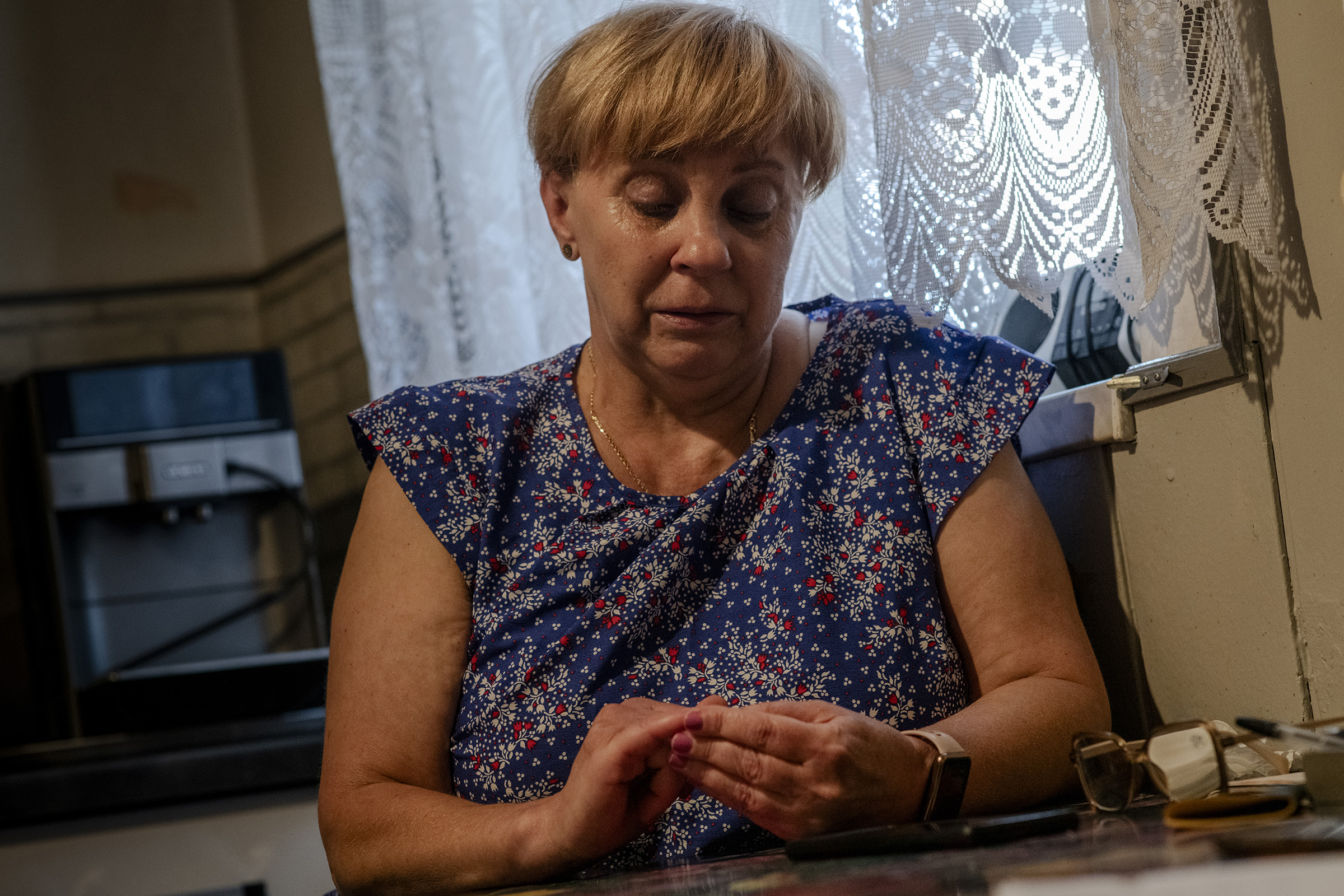 Izabela Sajbor’s mother Barbara Zientek sits in her home in Cwiklice, Poland, on July 31.