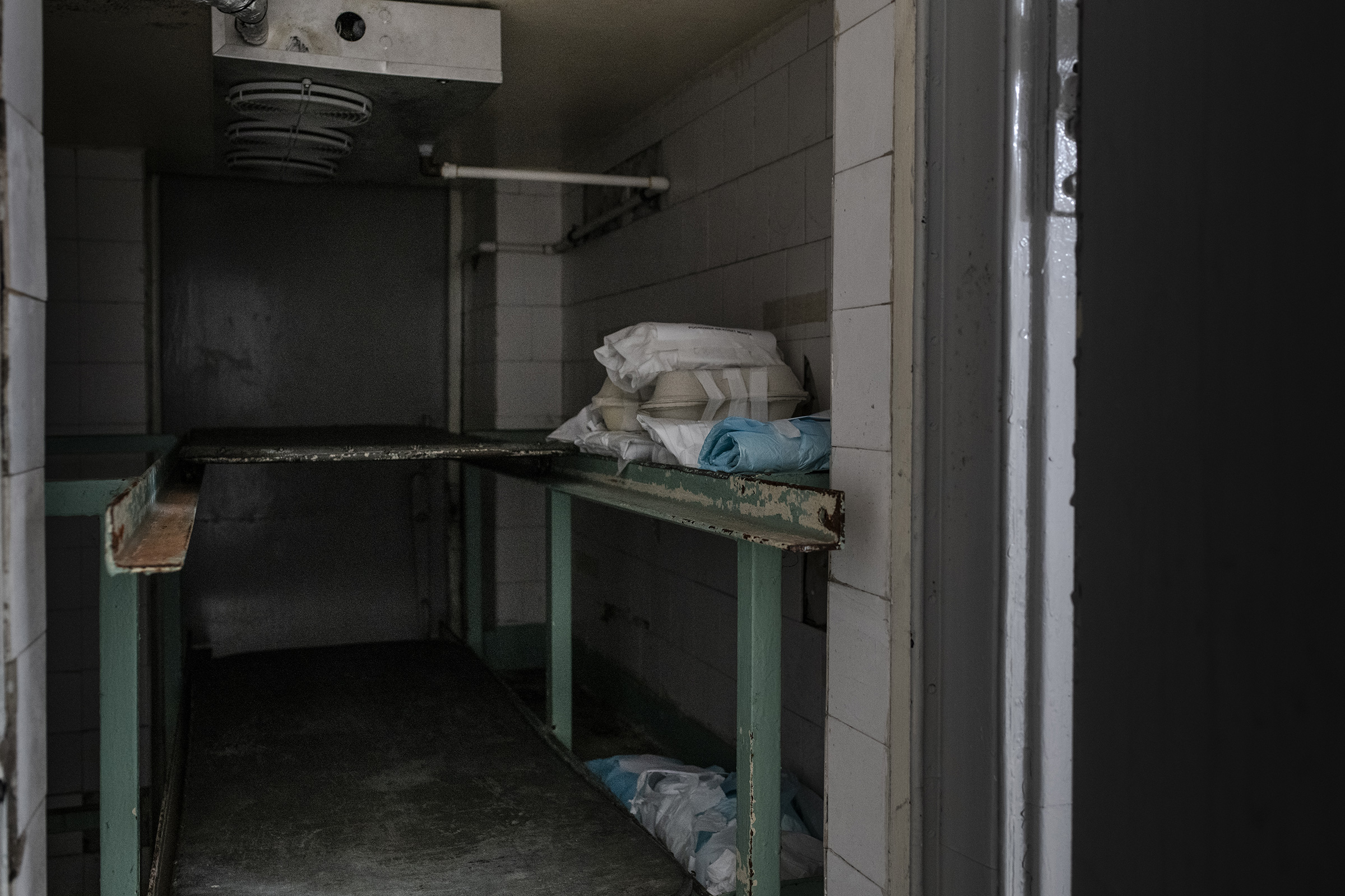 About 20 fetuses wrapped in cloth and paper in a fridge at a hospital morgue. The fetuses, many of which were born prematurely or with severe malformations, were abandoned.