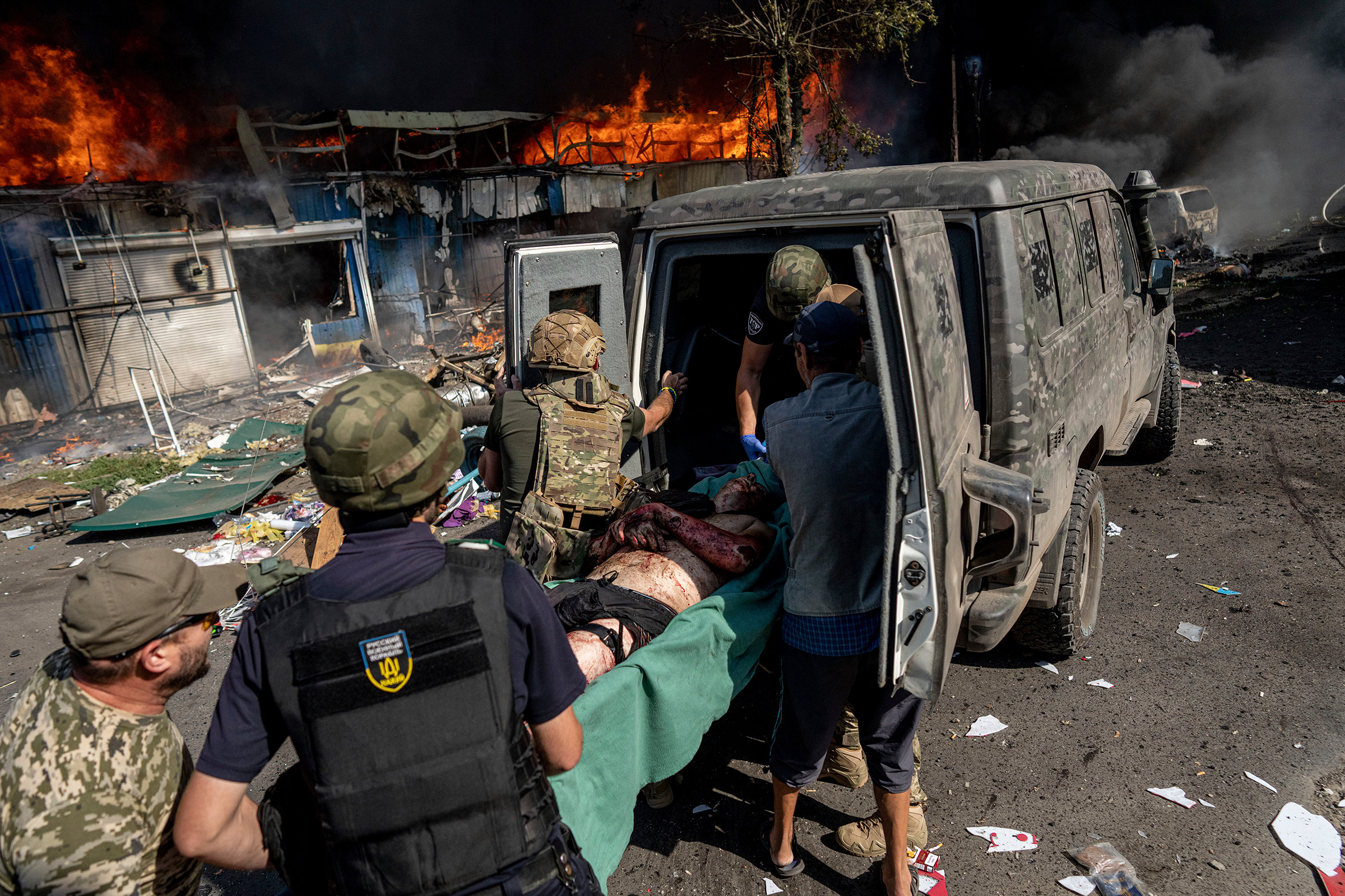 Paramedics help a wounded man after a Russian rocket attack in the eastern Ukrainian city of Kostiantynivka on Sept. 6, 2023.