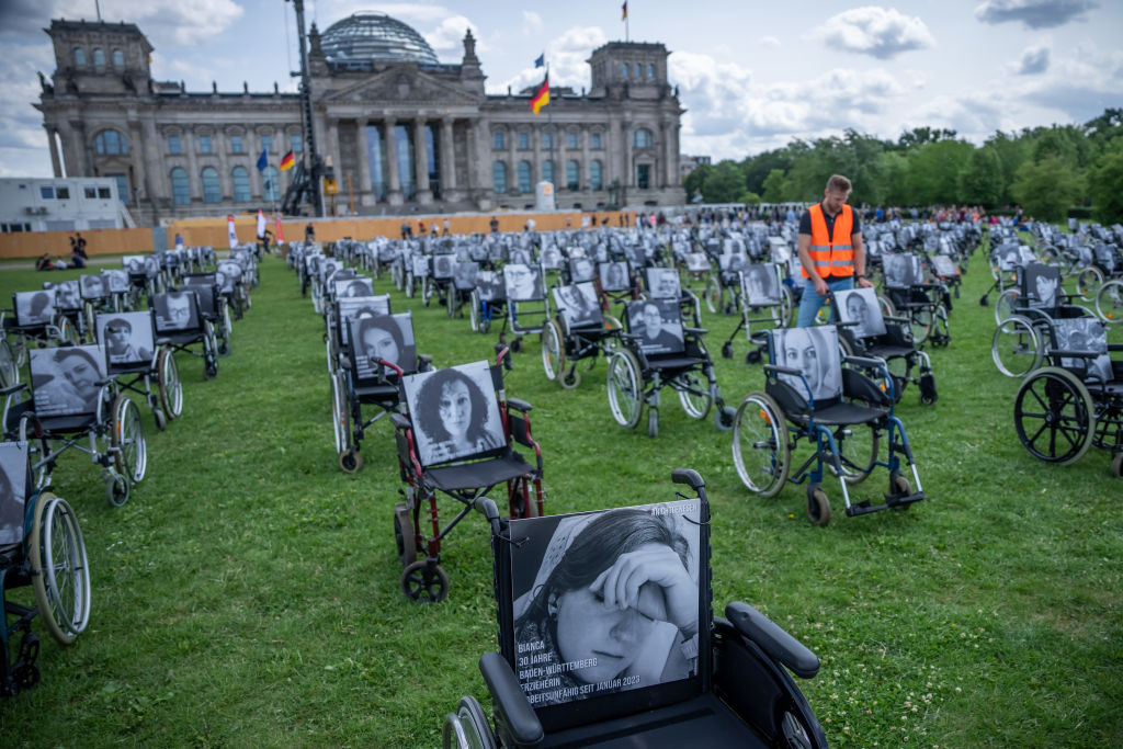 Wheelchairs are posed in front of the German Reichstag building in Berlin to protest a lack of progress on Long COVID.