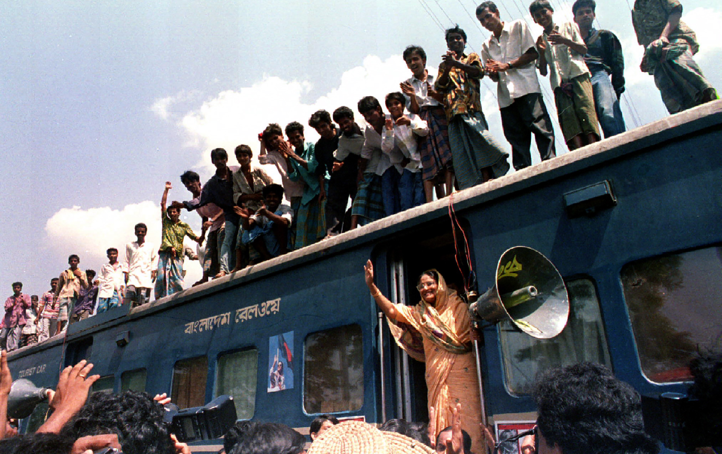 Hasina waves at followers as she begins the second phase of a train march to muster support to topple the government in September 1994.