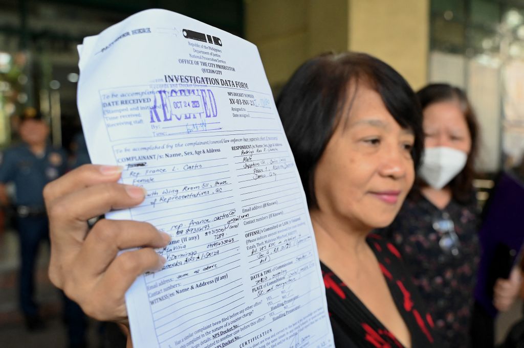 Philippine legislator France Castro shows a document after filing a criminal complaint against former Philippine President Rodrigo Duterte, at the Office of the Prosecutor in Quezon City on Oct. 24, 2023, following the malicious threats made by Duterte in a television interview.