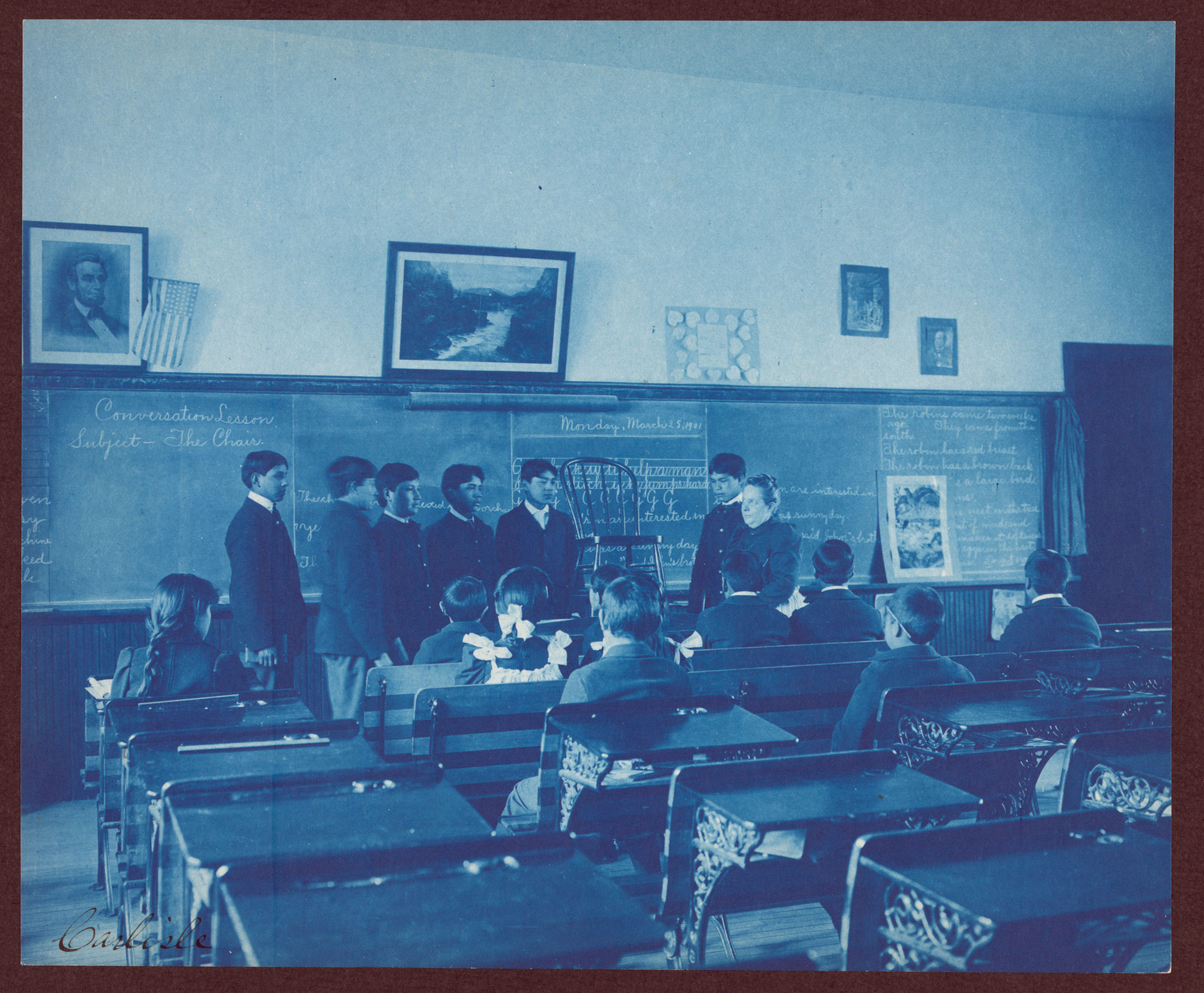 Six boys and a teacher at the Indian Industrial School, Carlisle, Pa.