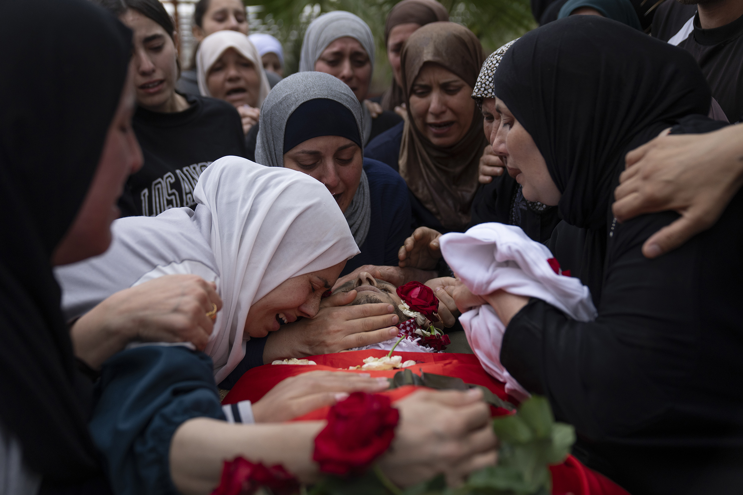 Palestinians mourn Nasser Barghouti, who was killed during an Israeli army raid in Beit Rima, West Bank, during his funeral on Oct. 29, 2023. (Nasser Nasser—AP)