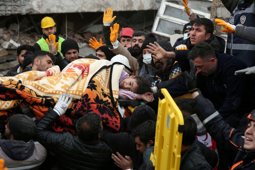 Rescuers carry out a girl from a collapsed building following an earthquake in Diyarbakir, Turkey on Feb. 6.