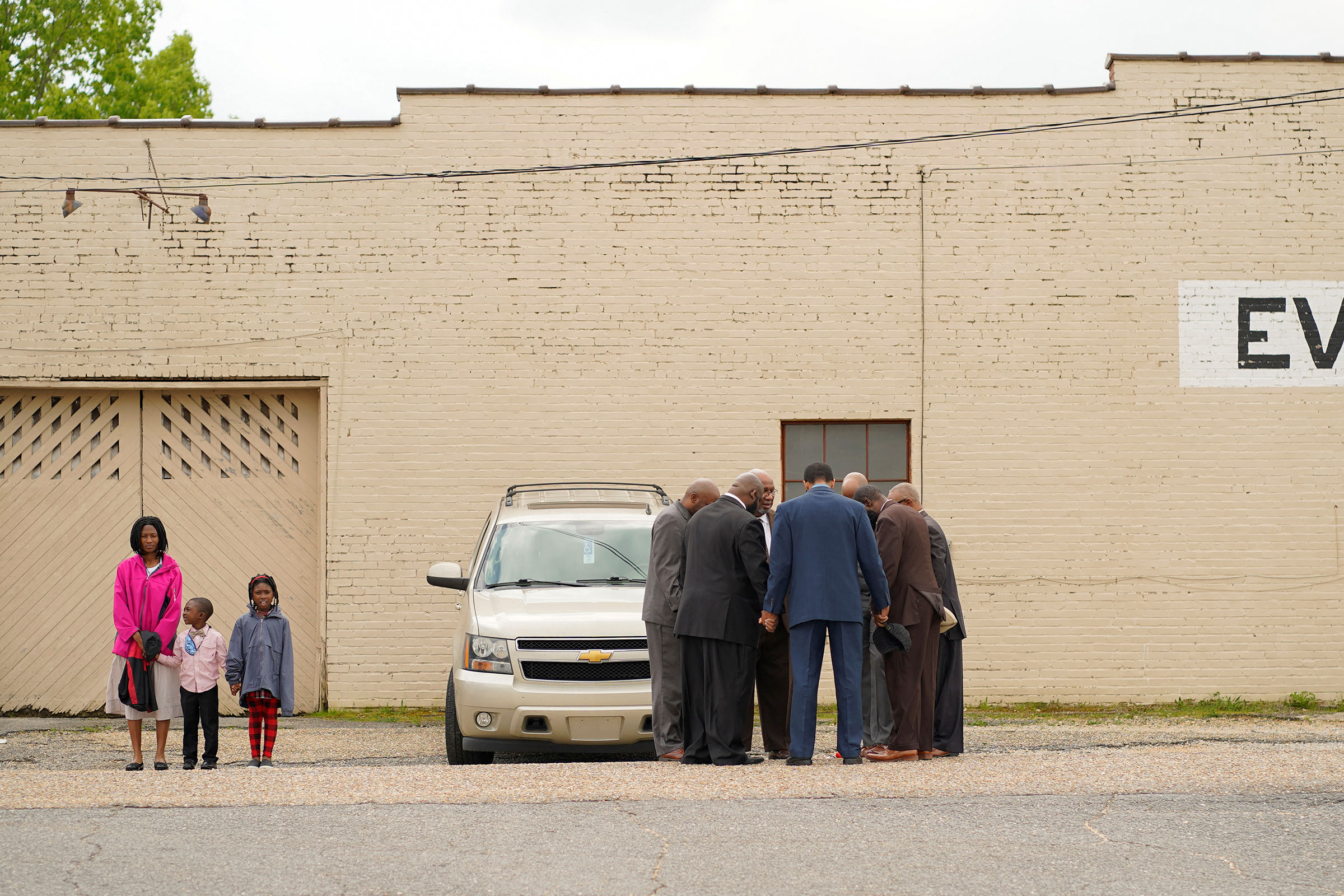 Pastors and community members pray ahead of a vigil the day after a shooting during a teenager's birthday party at Mahogany Masterpiece Dance Studio in Dadeville, Ala., on April 16.