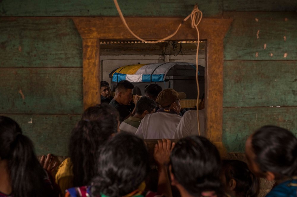 Relatives and friends during the burial of Marcos Abdón Tziquin Cuc, 21, in the village of Paquilá, Guatemala, on April 13, 2023.