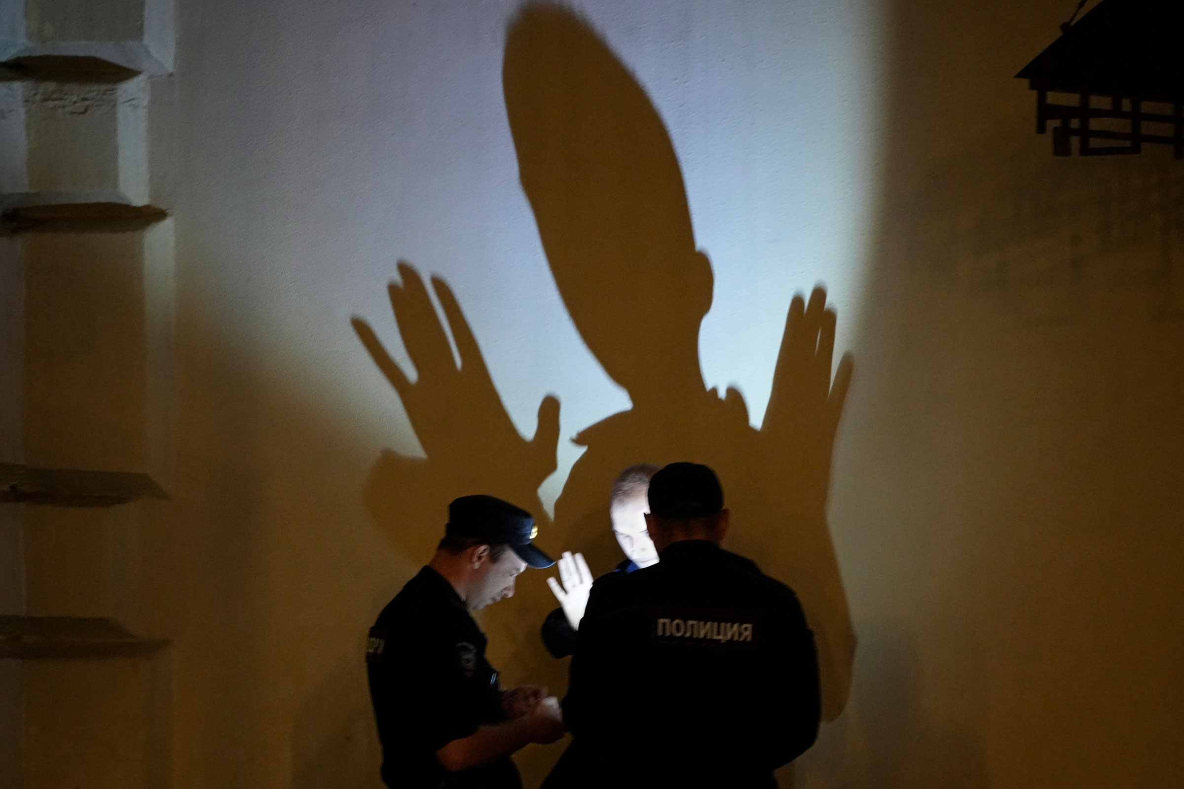 Police officers check documents of a man in central Moscow, Russia, on June 25.
