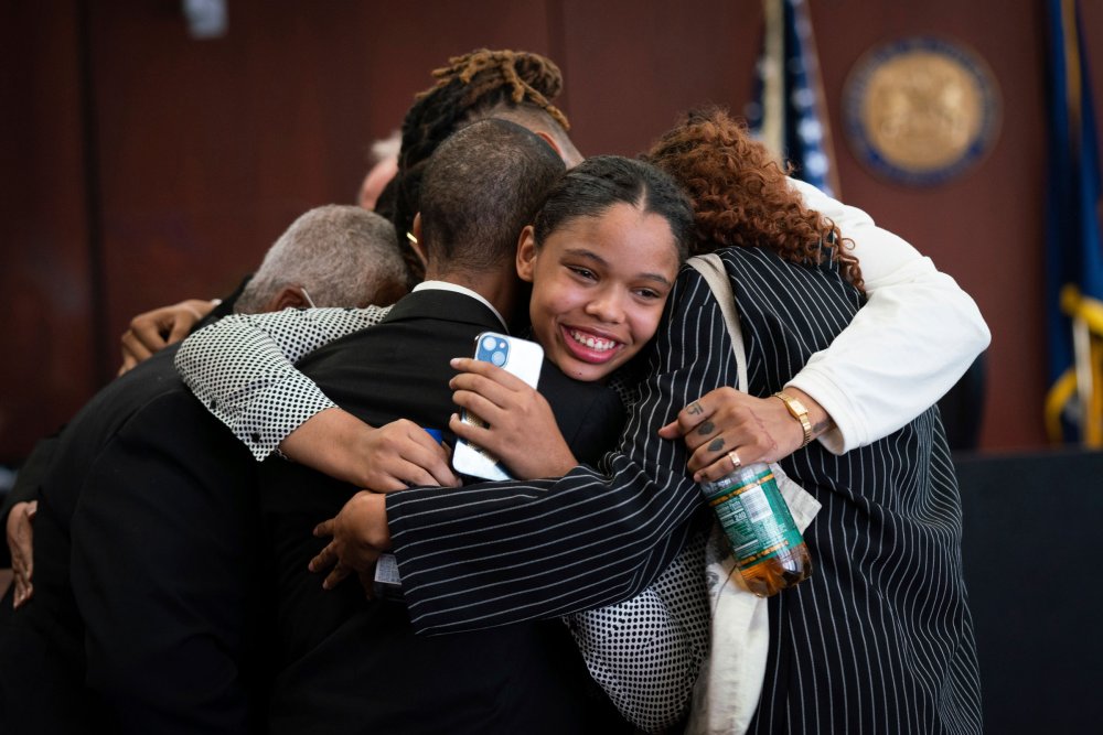 Aretha Franklin's granddaughter Grace Franklin, 17, smiles while embracing her family members after the jury decided in favor of a 2014 document during a trial over her grandmother's wills at Oakland County Probate Court in Pontiac, Mich., on July 11.