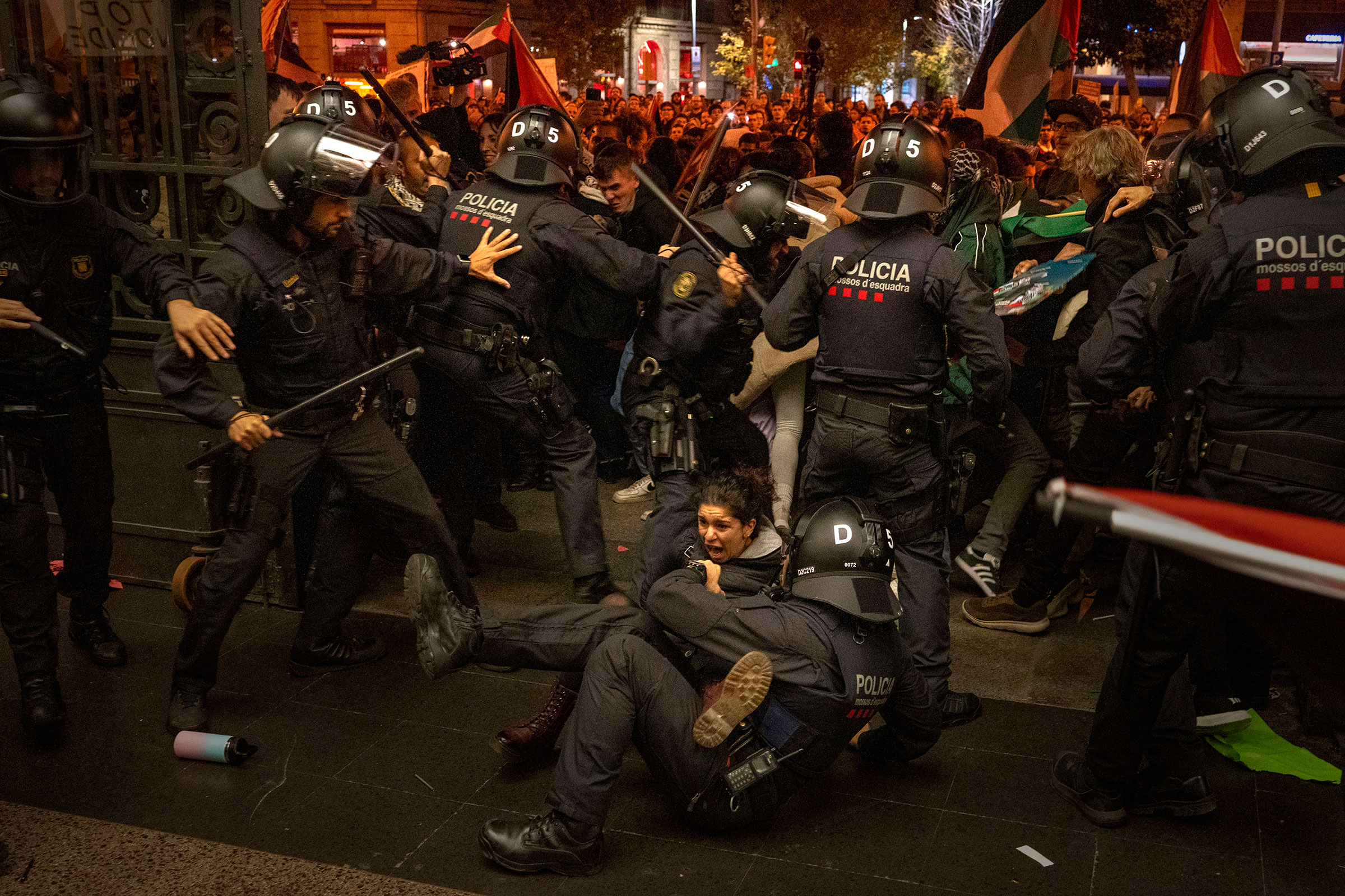 Police officers clash with pro-Palestinian demonstrators as they try to enter a train station in Barcelona, Spain, on Nov. 11. The protesters were part of a group of many thousands more who had earlier took part in an authorized march against Israel's response in Gaza to a deadly attack by Hamas on Oct. 7.