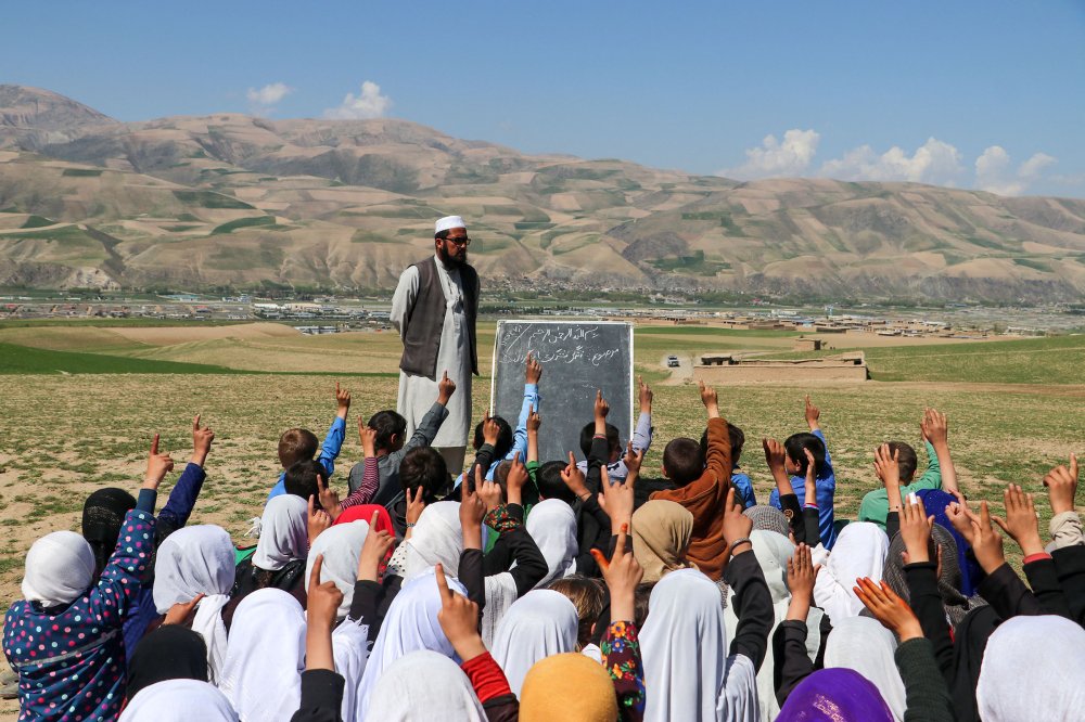 Afghan children attend a class at an open air school on the outskirts of Fayzabad district, Badakhshan province on March 27.