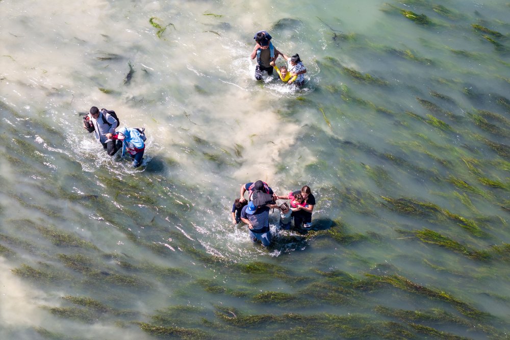 Immigrants struggle through the current of the Rio Grande while crossing from Mexico into the United States in Eagle Pass, Texas, on Sept. 27.