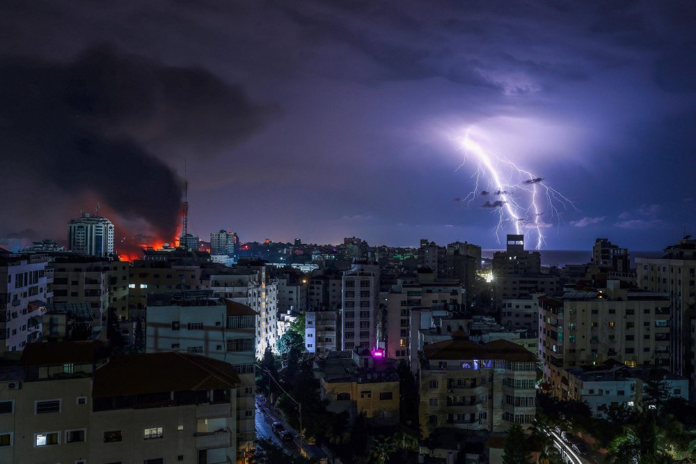 Lightning strikes as smoke billows following an Israeli airstrike in Gaza City on Oct. 9.