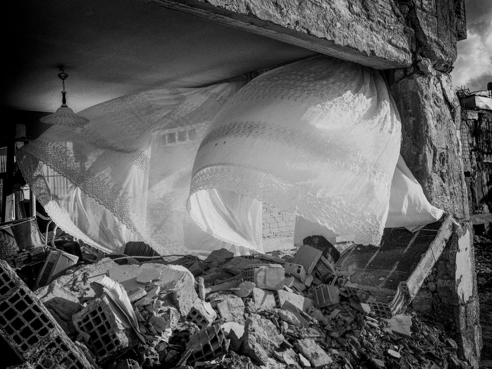 Curtains blowing in the wind after an earthquake demolished the building in the center of Antakya, Turkey, on April 11.