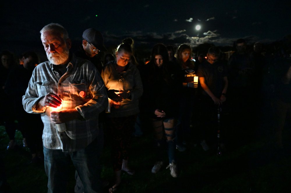 Richard Wilcox, left, weeps as community members gather after the tragic Lewiston mass shooting for a vigil to heal at Worumbo Riverfront Park in Lisbon Falls, Maine, on oct. 28. 18 people were killed in the assault.
