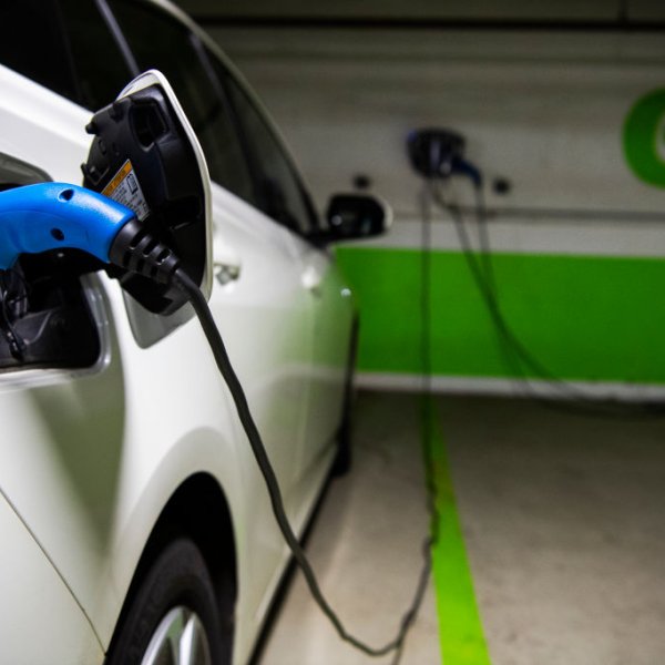 A Toyota Prius is seen connected to a electric vehicle charging station in a Washington, D.C., parking garage on March 31, 2021.