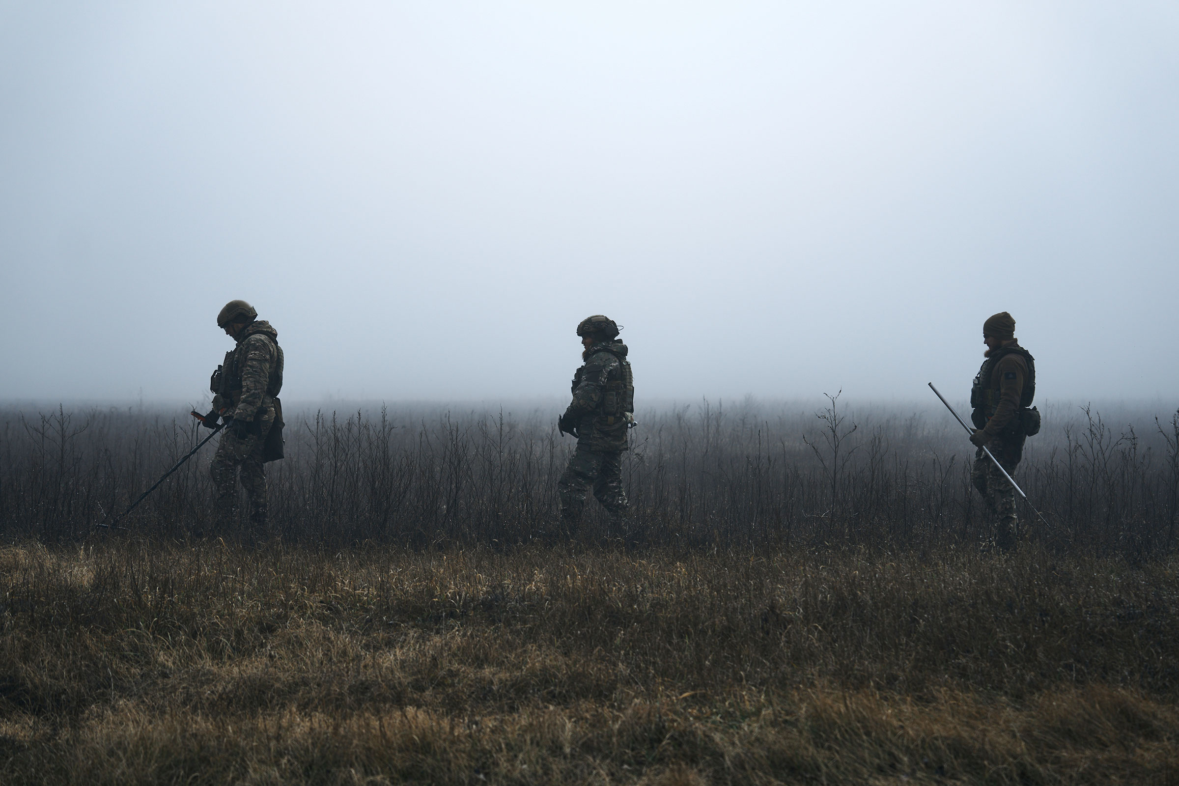 Ukrainian military sappers demine the road in a fog close to Kherson, Ukraine, on Feb. 3, 2023.