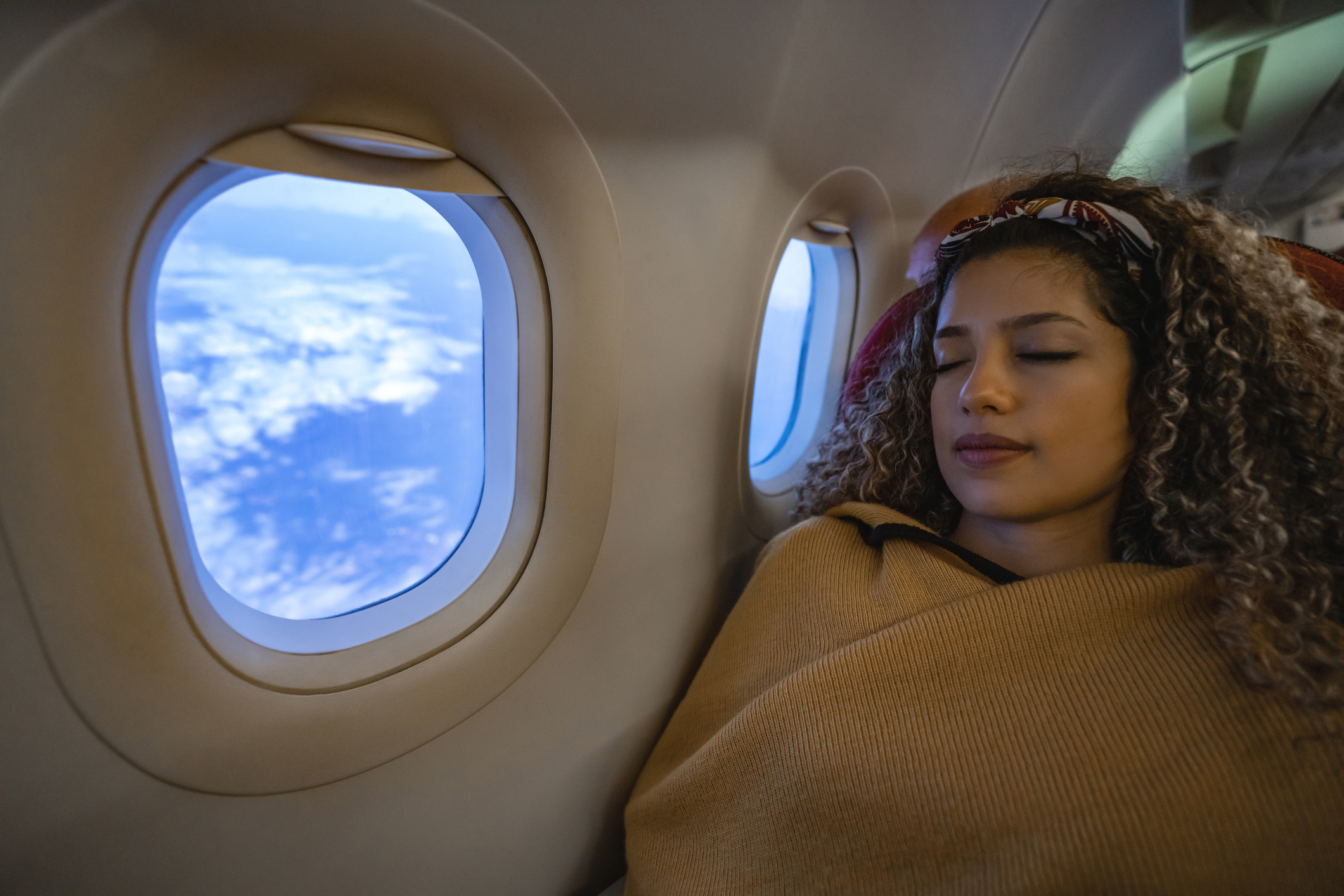 Woman traveling by plane and sleeping