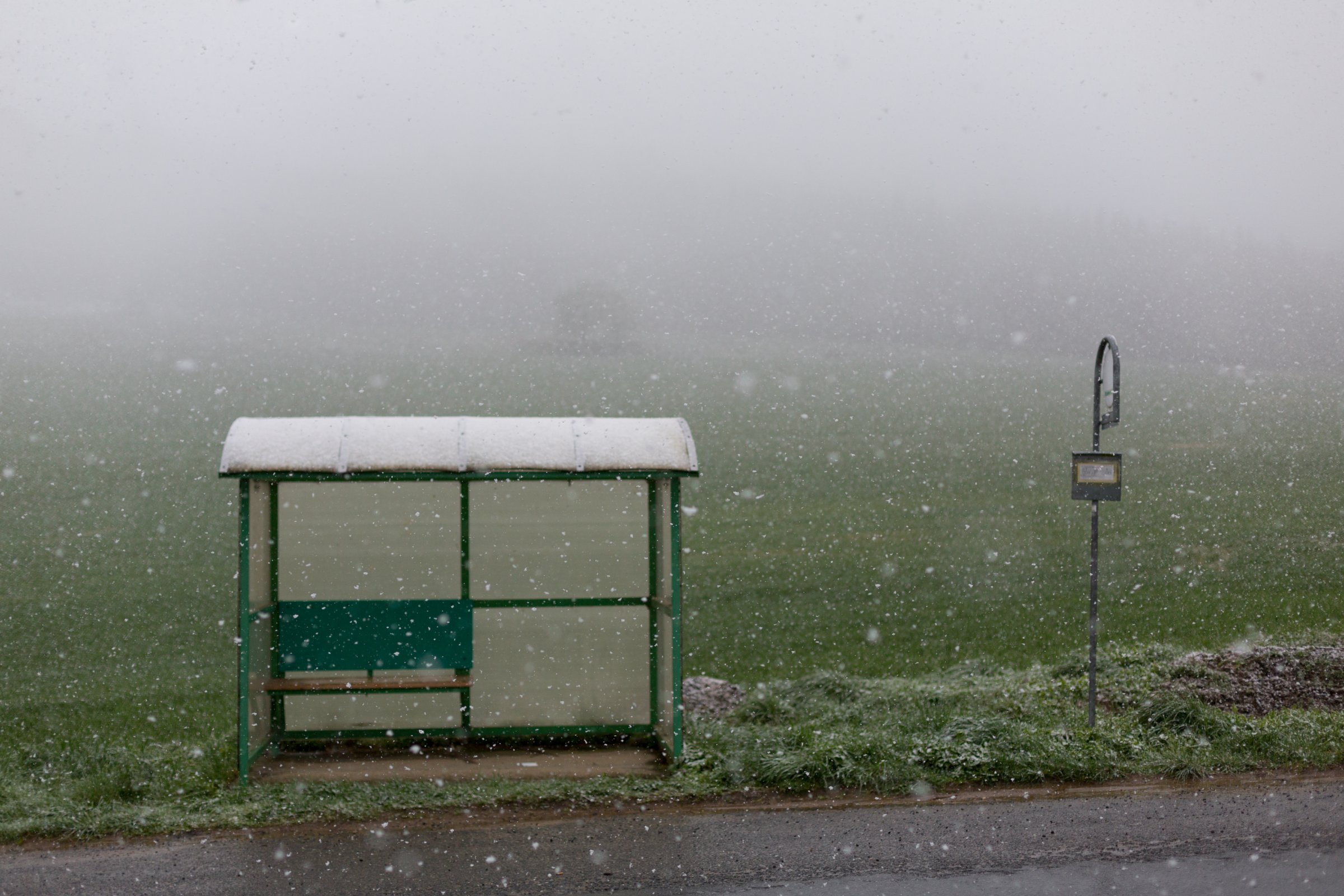 Bus stop, heavy snowfall, fog, road