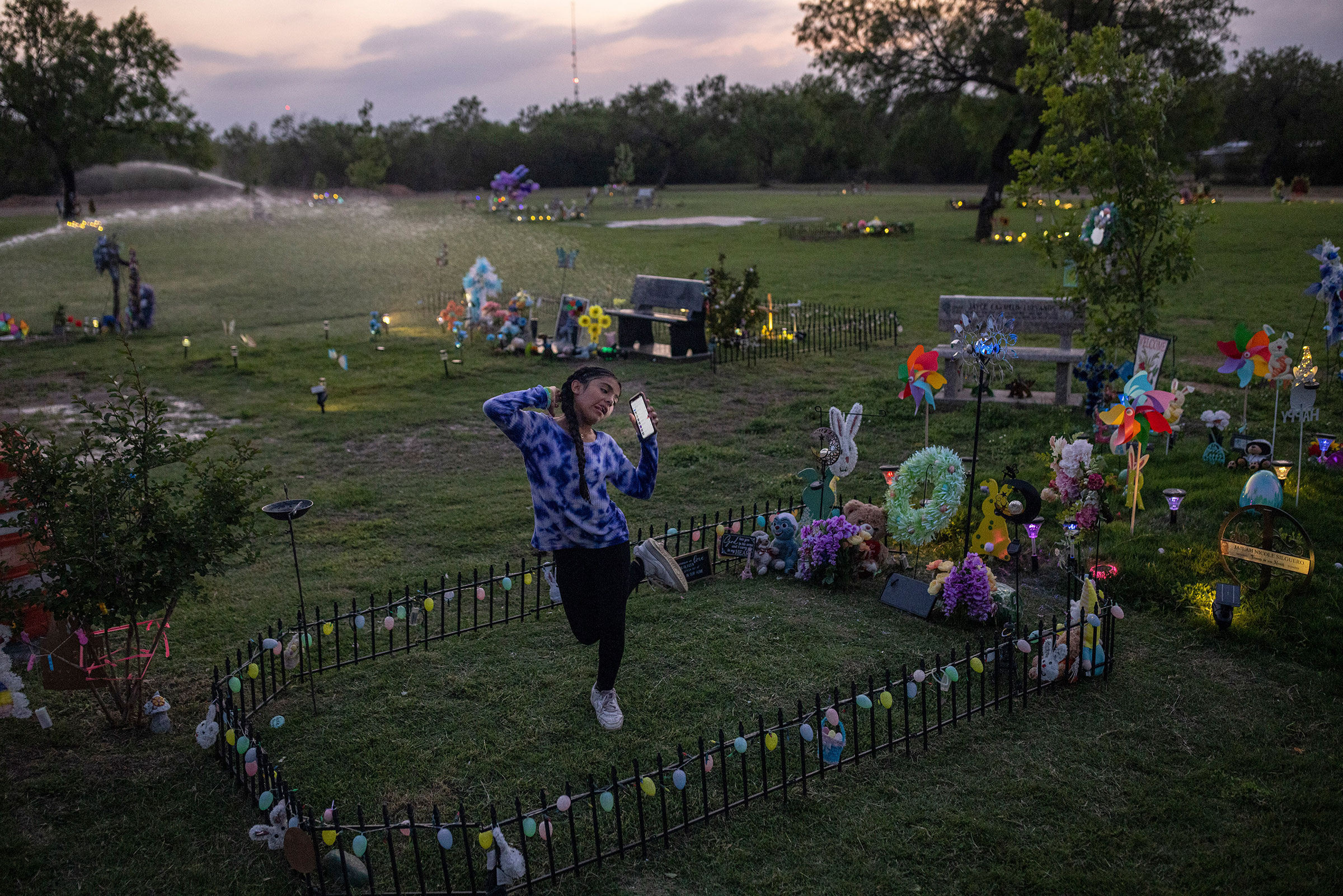 Caitlyne Gonzales, who lost many of her friends in the shooting, sang and danced to Taylor Swift songs at Jacklyn Cazares' grave in Uvalde, Texas, on April 19. One year after 19 children and two teachers were killed at Robb Elementary, the cemetery where most of the victims are buried has become an anchor in their families' lives.