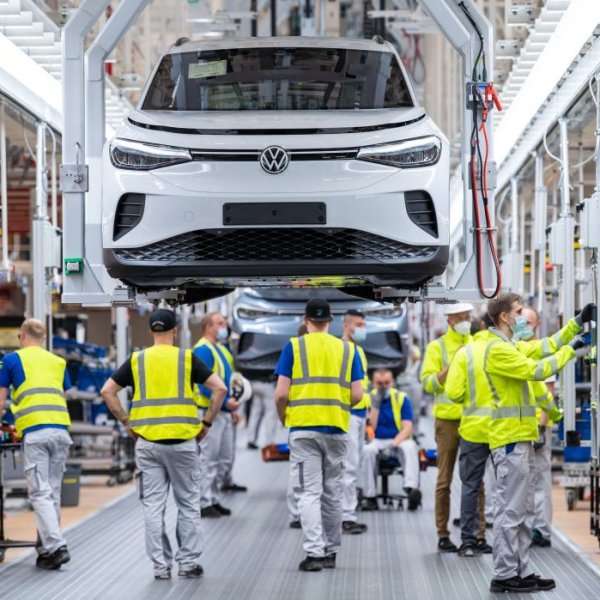 Employees work at the assembly line for the Volkswagen (VW) ID 4 electric car in the production site of Emden, northern Germany, on May 20, 2022.