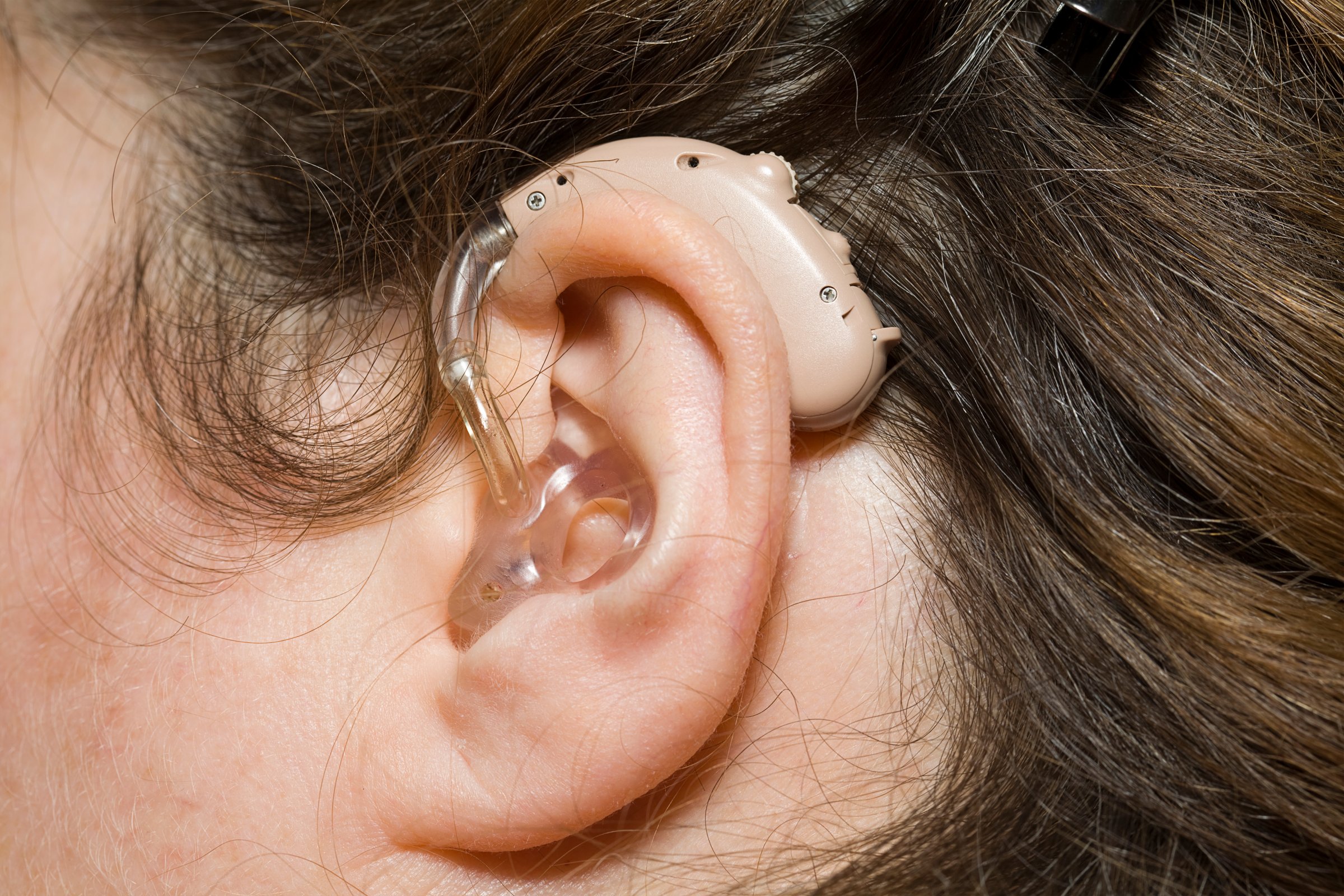 Close up of woman wearing digital hearing aid