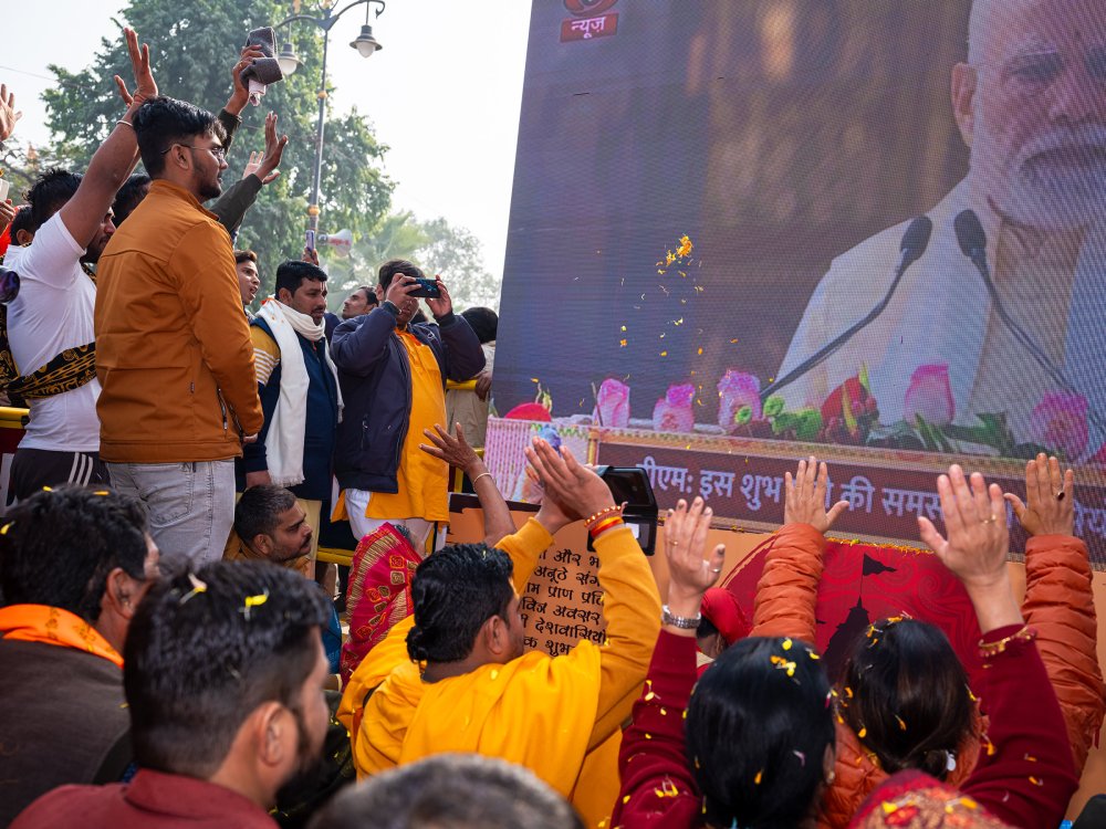 Devotees cheer, worship and prostrate before one of the many LCD screens placed across Ayodhya city showing a live telecast of the Ram temple consecration ceremony on Jan. 22. The same telecast was also shown at Times Square in New York and other parts of the world.