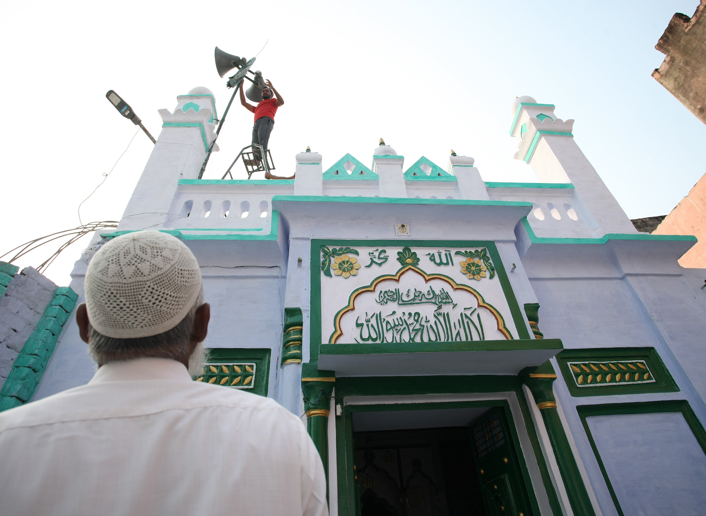 A Indian Muslim man stand outside of a mosque in Ayodhya, India, one day after the Supreme Court's verdict on a disputed religious site, on Nov. 10, 2019.