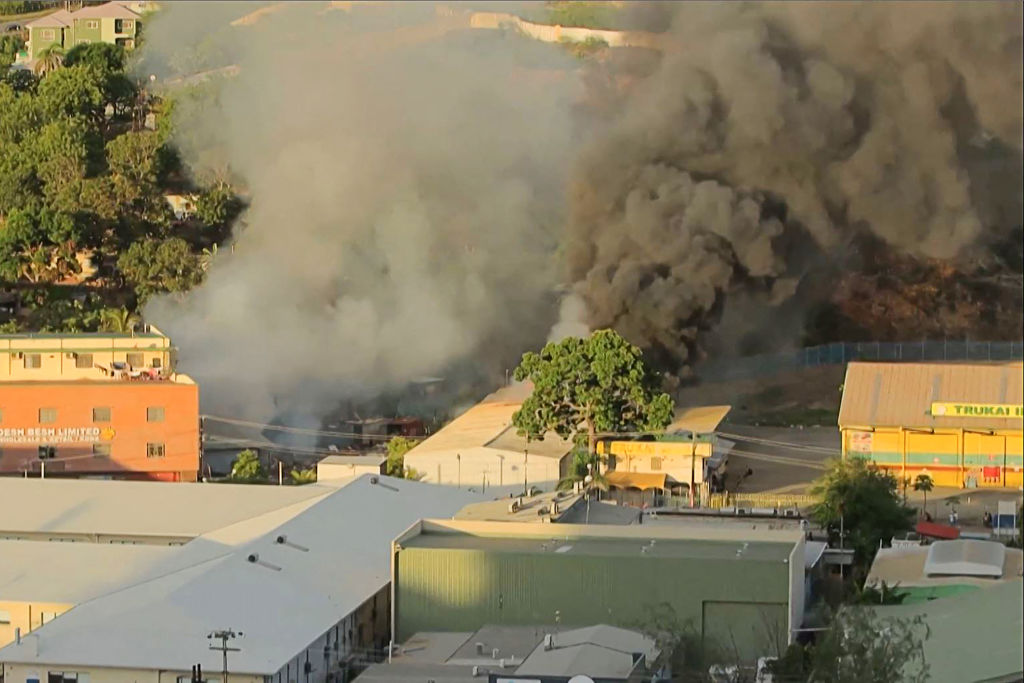 This screen grab from AFPTV video footage taken on January 10, 2024 shows smoke billowing from a building fire amid a state of unrest in Port Moresby, Papua New Guinea.