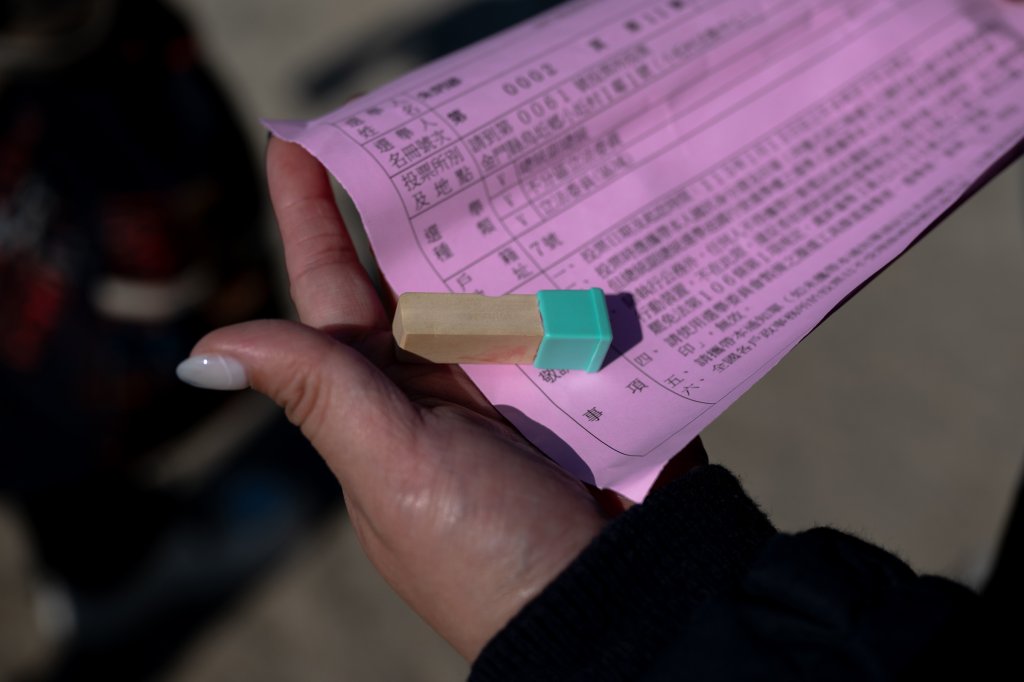 A Wuqiu resident uses a personal stamp as a signature to vote in the 2024 presidential elections on Jan 13.