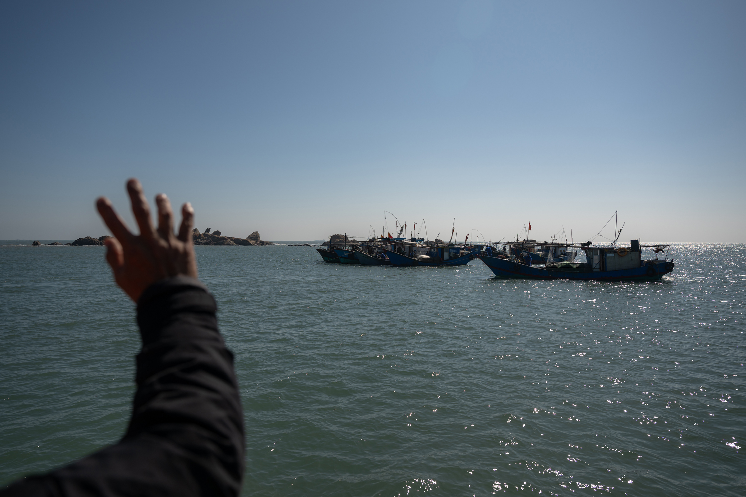 A Wuqiu villager says hello to Chinese fishermen who are from Meizhou Island just an hour away, Jan 13, 2024.
